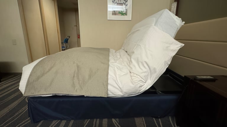 Side view of the adjustable bed in a partially raised position.