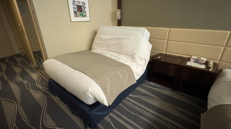 One of the beds in the accessible room is partially reclined, showing its adjustable feature.