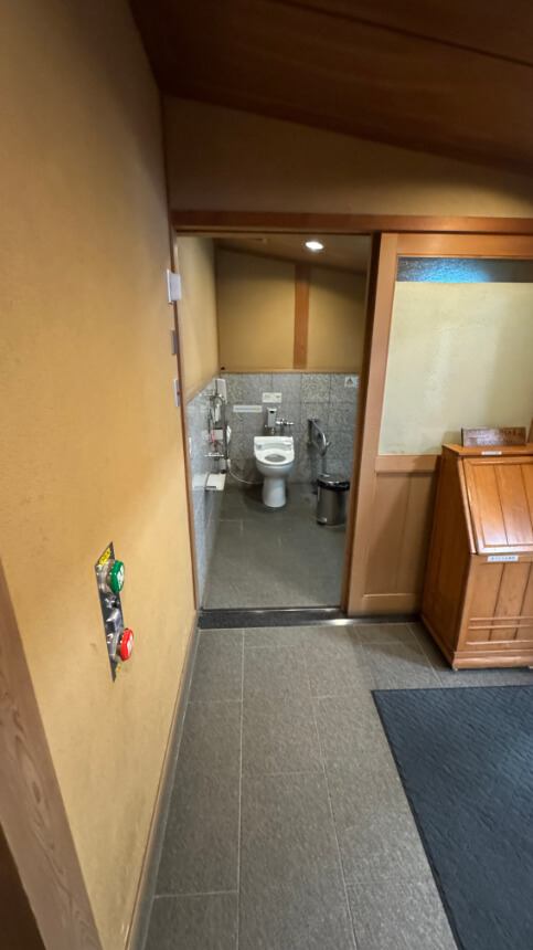 Entrance to the accessible toilet near the restaurant, with buttons to open the automatic door.