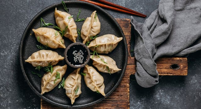 Gluten-free dumplings at T’s Kitchen Tokyo served with soy sauce and garnished with green onions