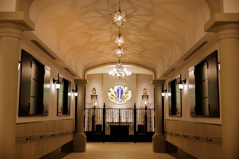 Elegant hallway with star-shaped lights, stained glass, and wrought iron gate at Hotel Monterey Himeji’s chapel interior.