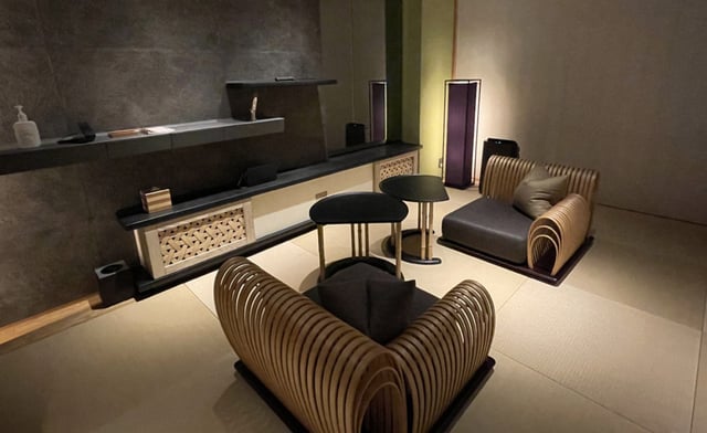 Tatami-style lounge at Hoshinoya Tokyo with modern wooden seating and soft lighting. Accessible rooms include a roll-in shower.