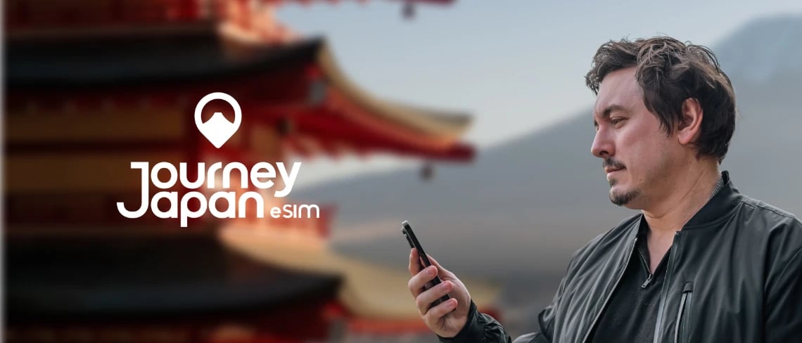Man checking smartphone near a Japanese pagoda, promoting Journey Japan eSIM for reliable mobile data while traveling in Japan.