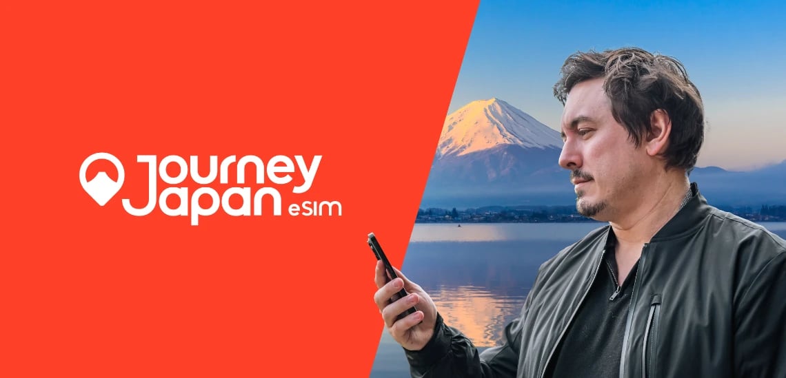 Man checking smartphone with Mt Fuji in the background, promoting Journey Japan eSIM for reliable mobile data while traveling in Japan.