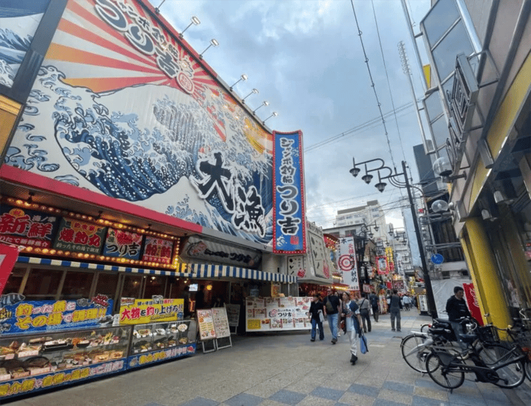 accessible osaka shinsekai daytime tour street with large signs 768x588