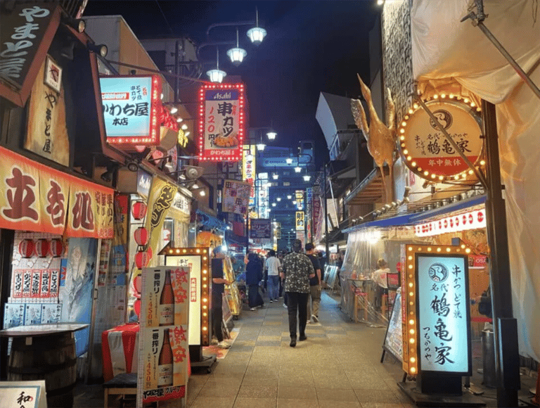 accessible osaka shinsekai evening tour colorful restaurant signs alley 768x581