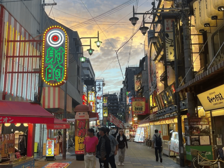 accessible osaka shinsekai evening tour neon signs street at sunset 768x576