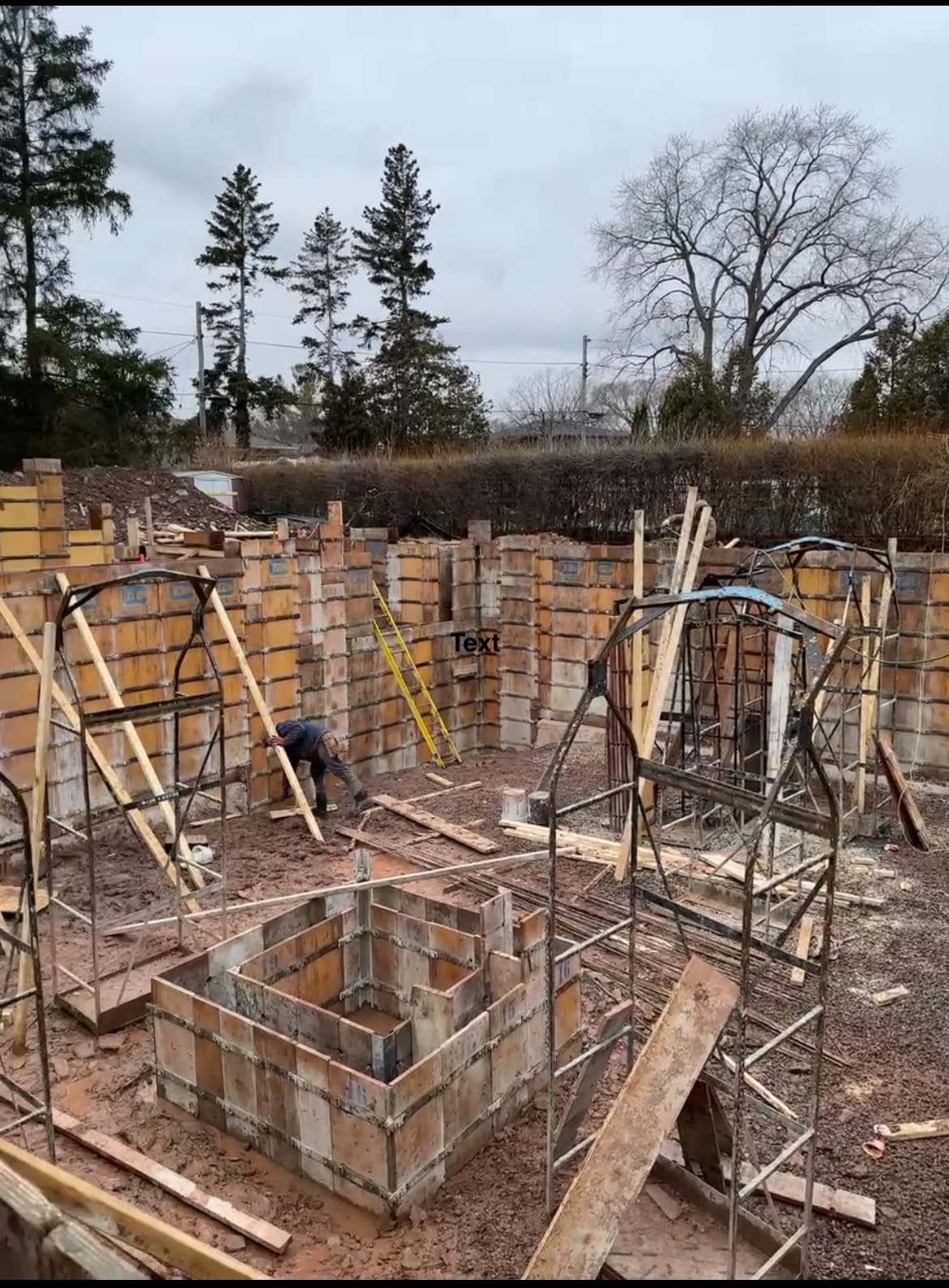 Formwork installation and wall assembly for custom home foundation in Burlington