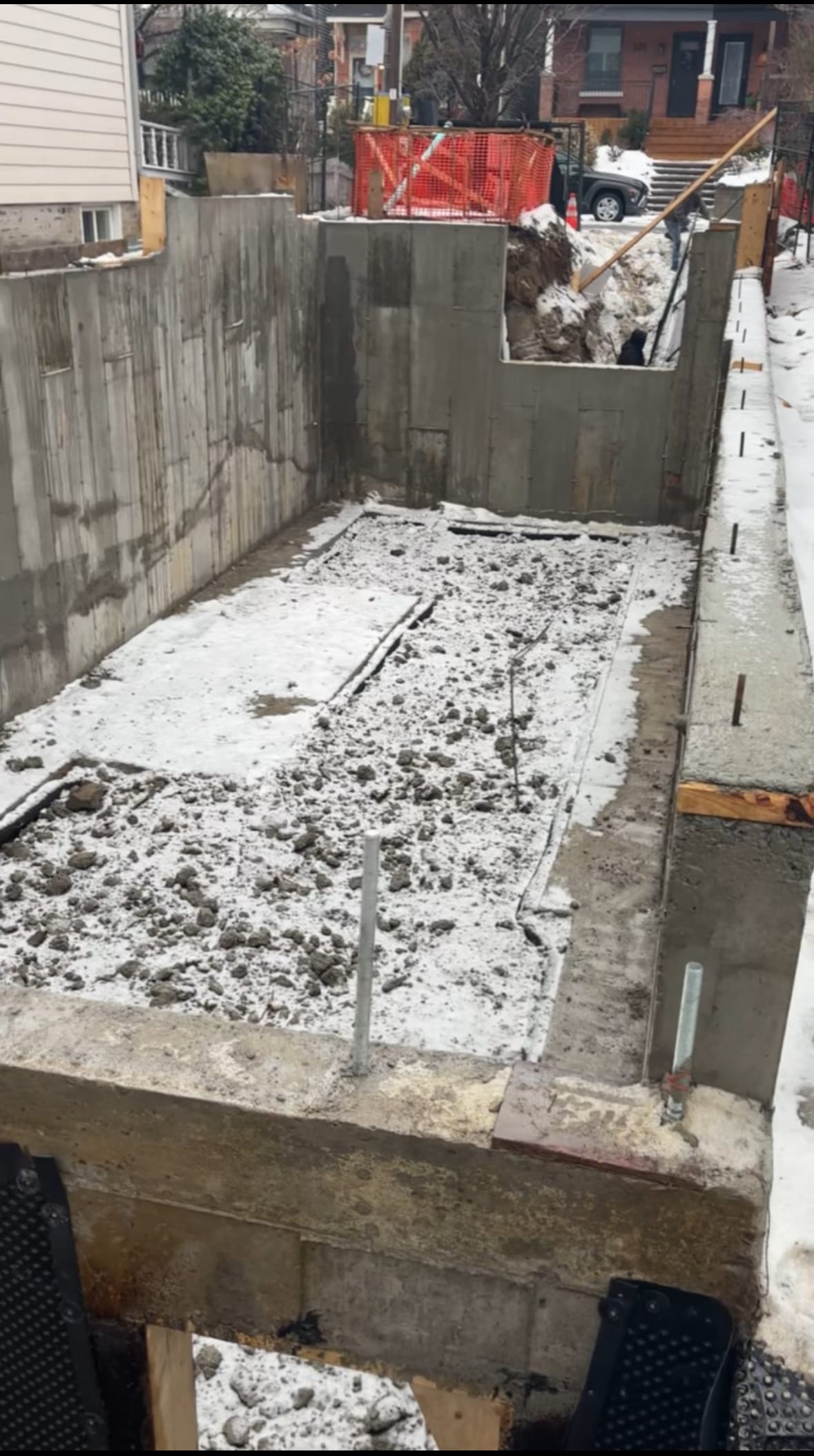 Freshly poured concrete footing with blindside wall preparation in East York foundation project