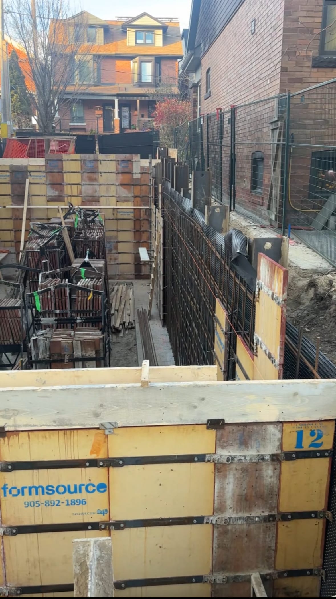 Dual blindside wall configuration with intensive rebar installation for East York custom home foundation