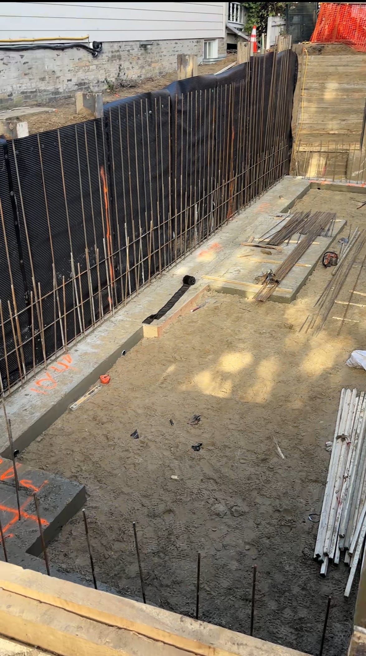 Foundation wall assembly with rebar placement against shoring in East York residential project