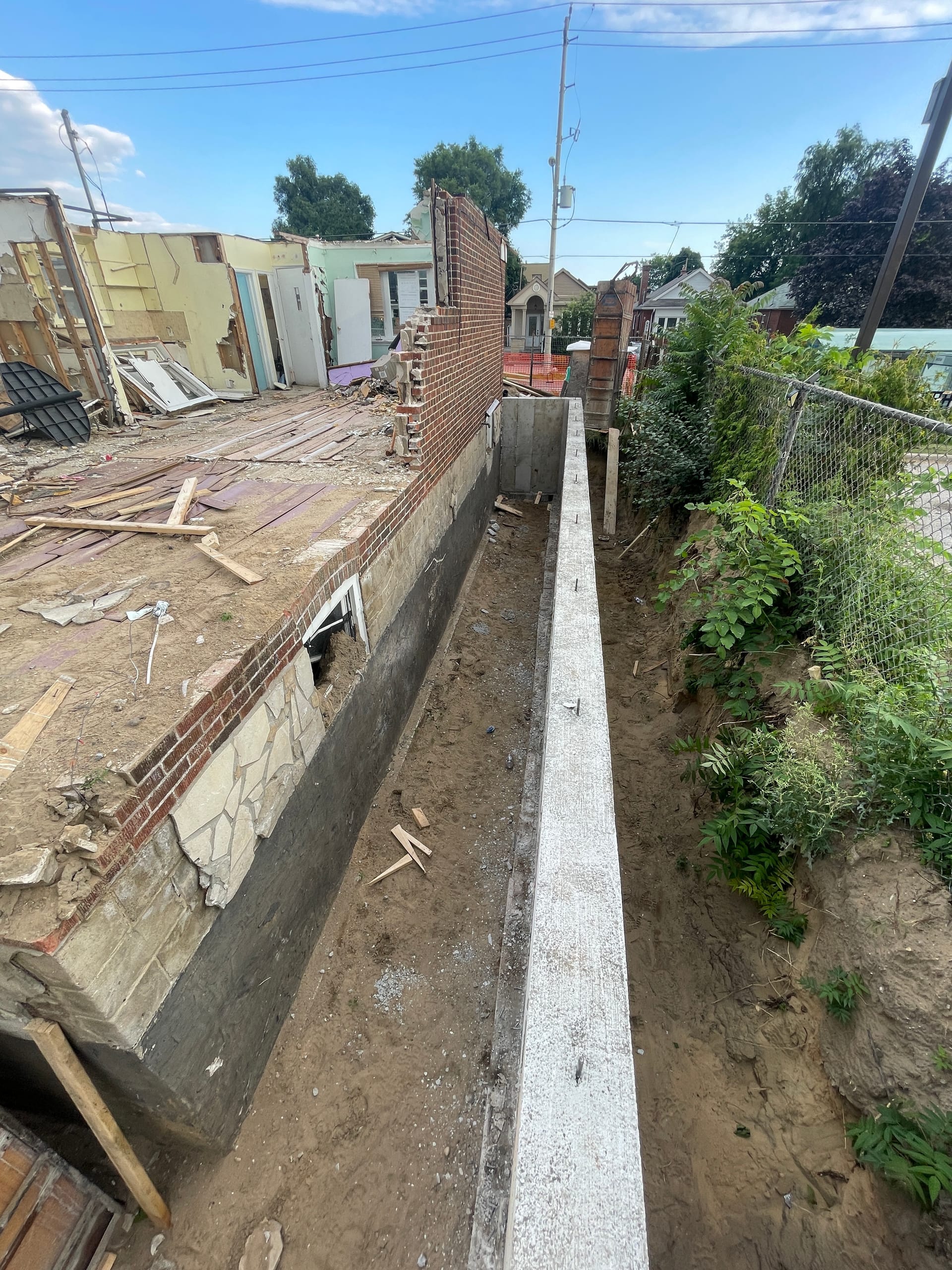 Active waterproofing application on East York foundation extension with weeping tile and membrane
