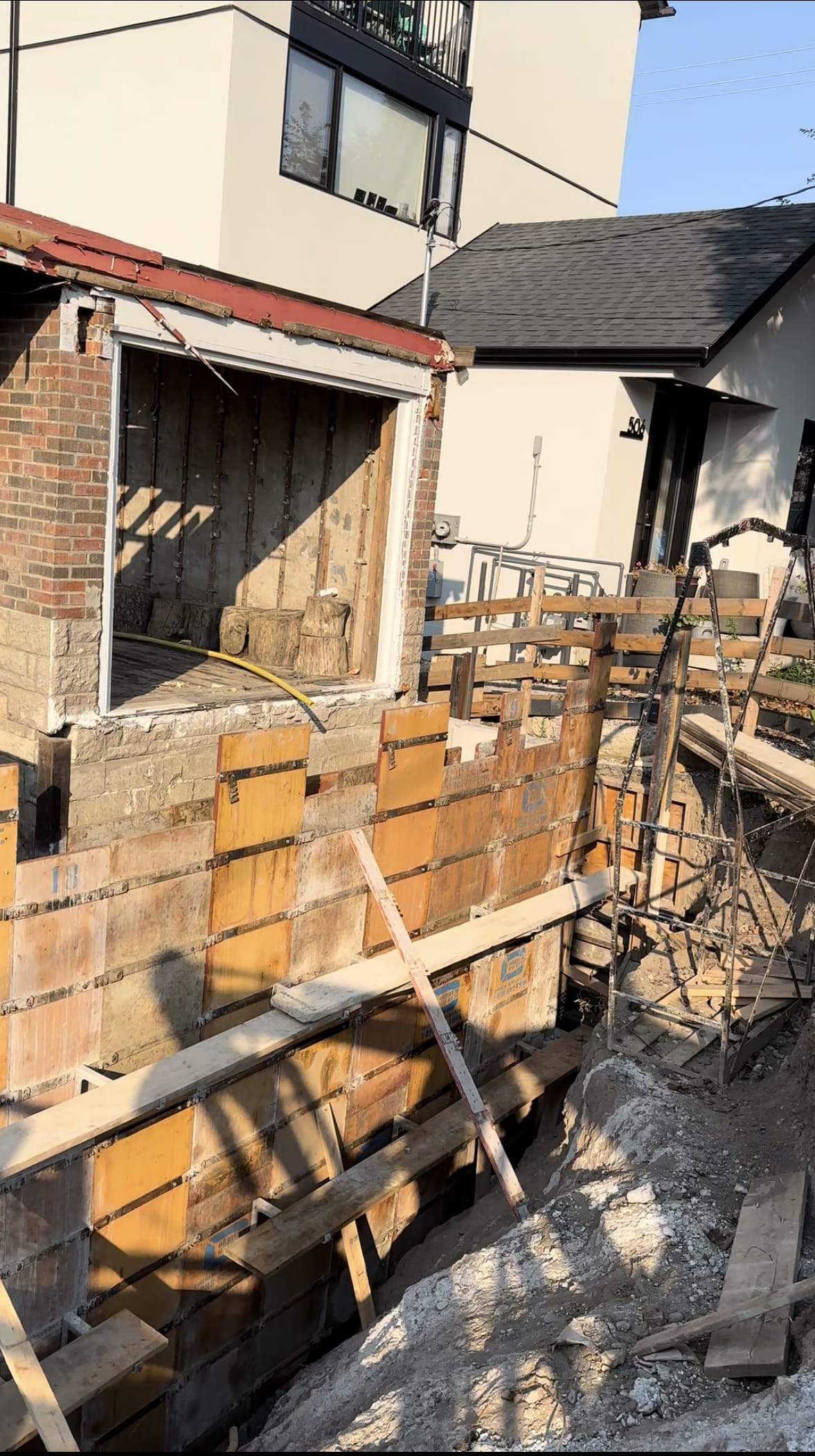 Braced formwork system for East York foundation extension walls awaiting concrete delivery