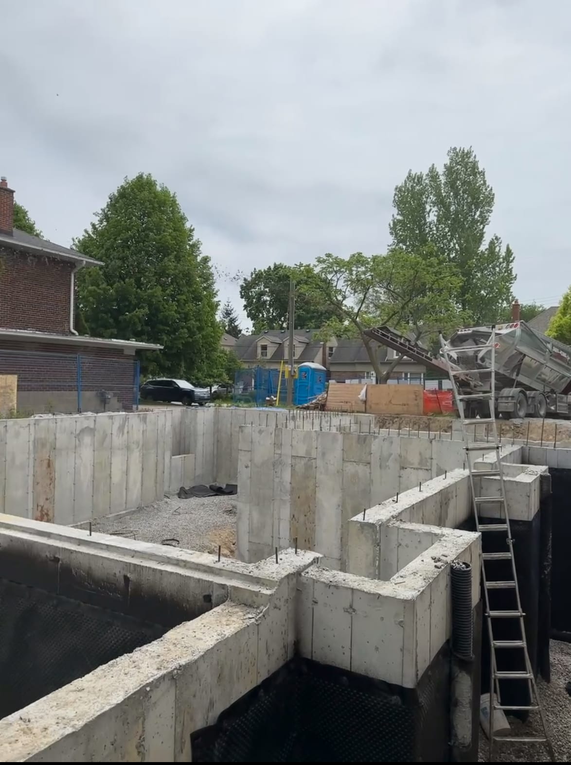 Concrete foundation wall formwork assembly with rebar installation at Etobicoke residential construction site