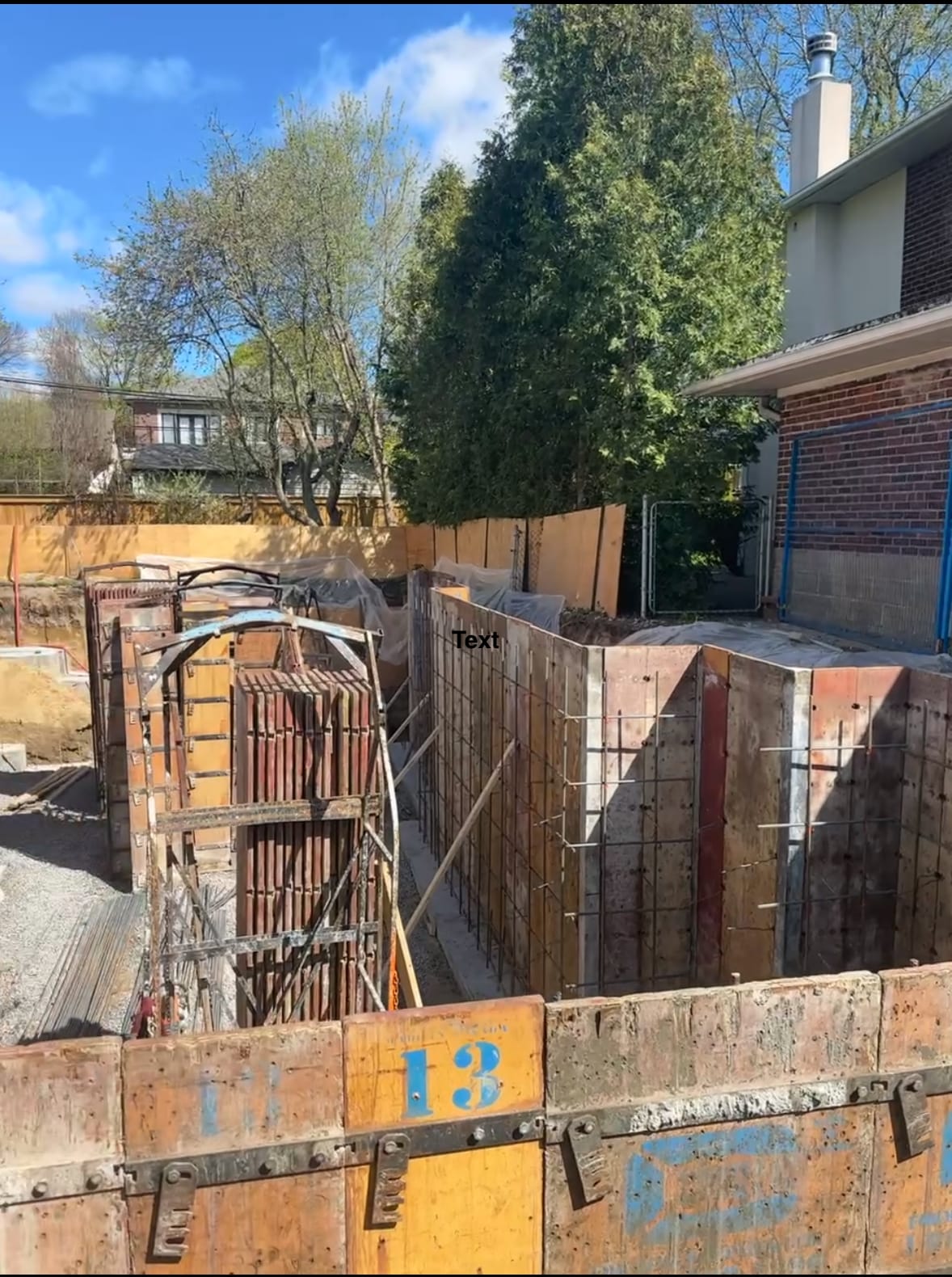 Waterproofed residential foundation with drainage stone installation underway in Etobicoke Toronto