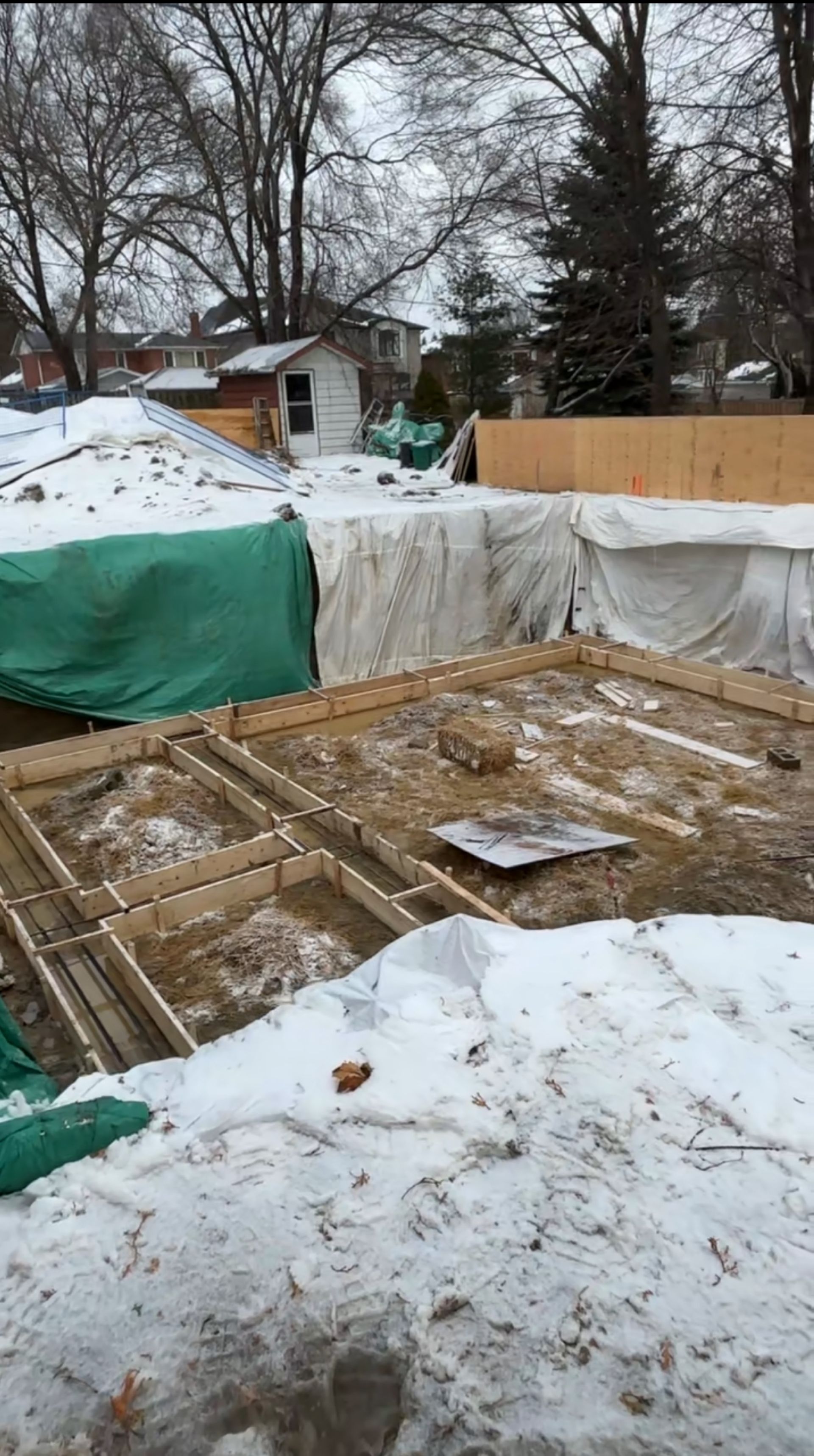 Garden suite footing formed through icy muddy conditions at Downing Street