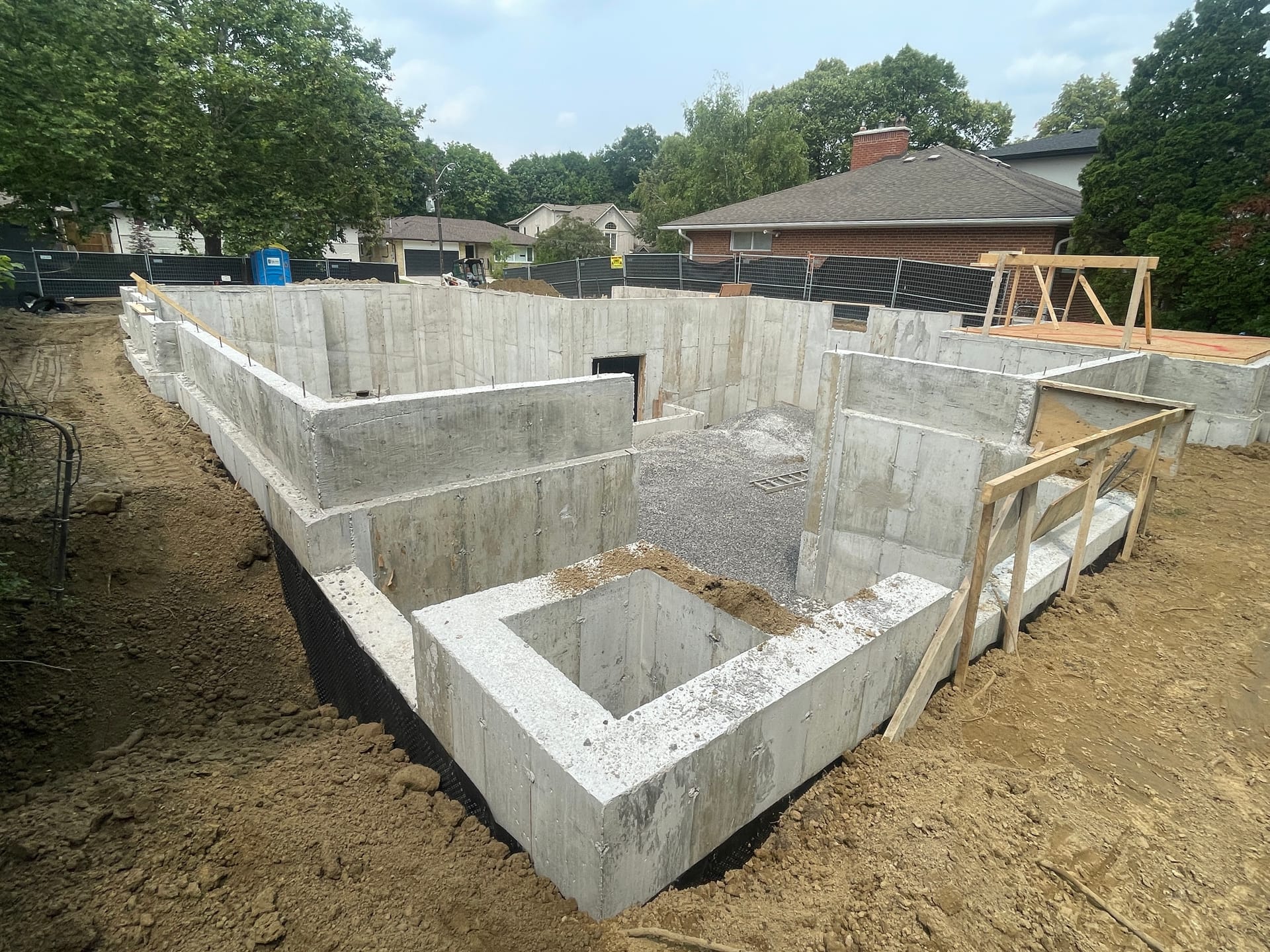 Custom home foundation with waterproofing visible after backfill in Etobicoke Toronto