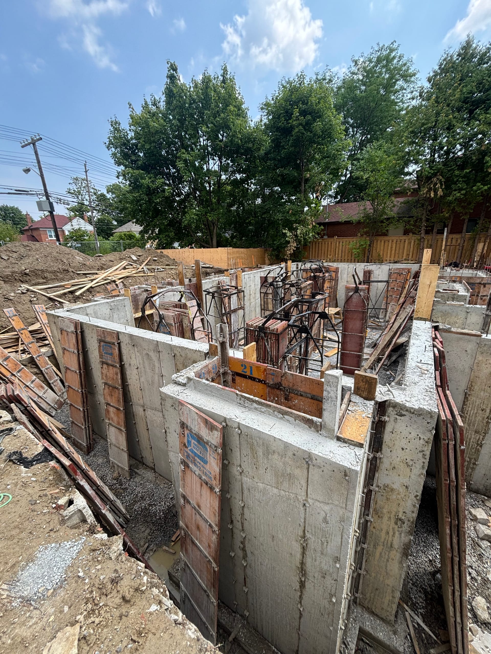 Braced multiplex foundation walls prepared for concrete pour in Etobicoke development