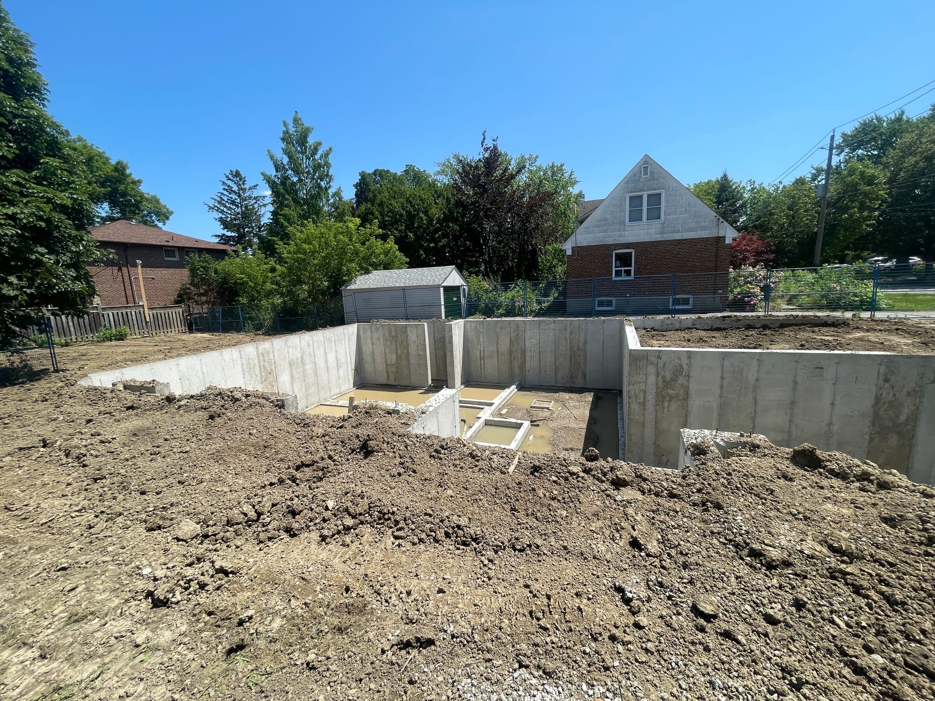 Backfilled residential foundation walls in Etobicoke showing completed concrete forming work