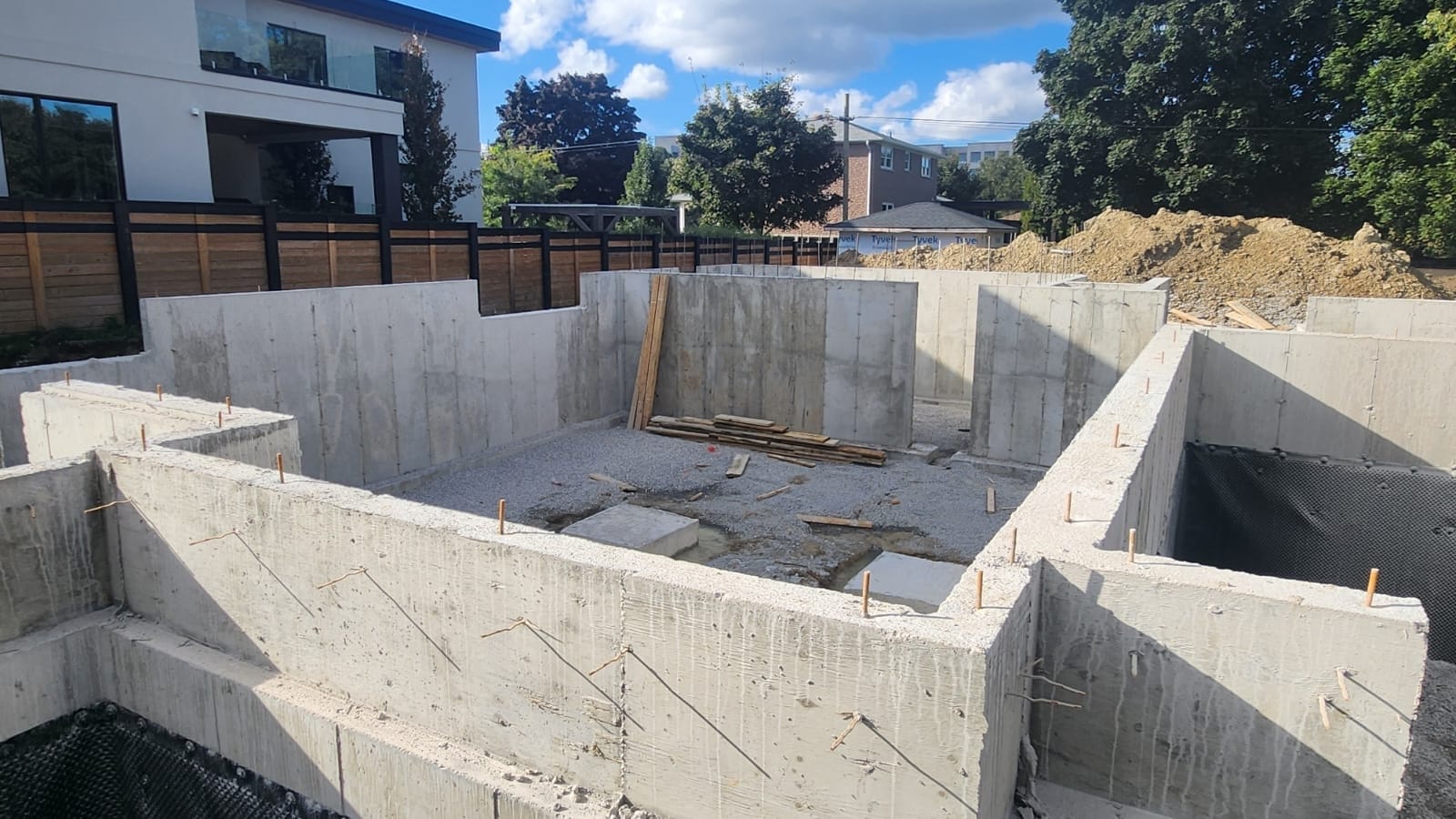 Angled view of waterproofed concrete foundation walls King City Ontario