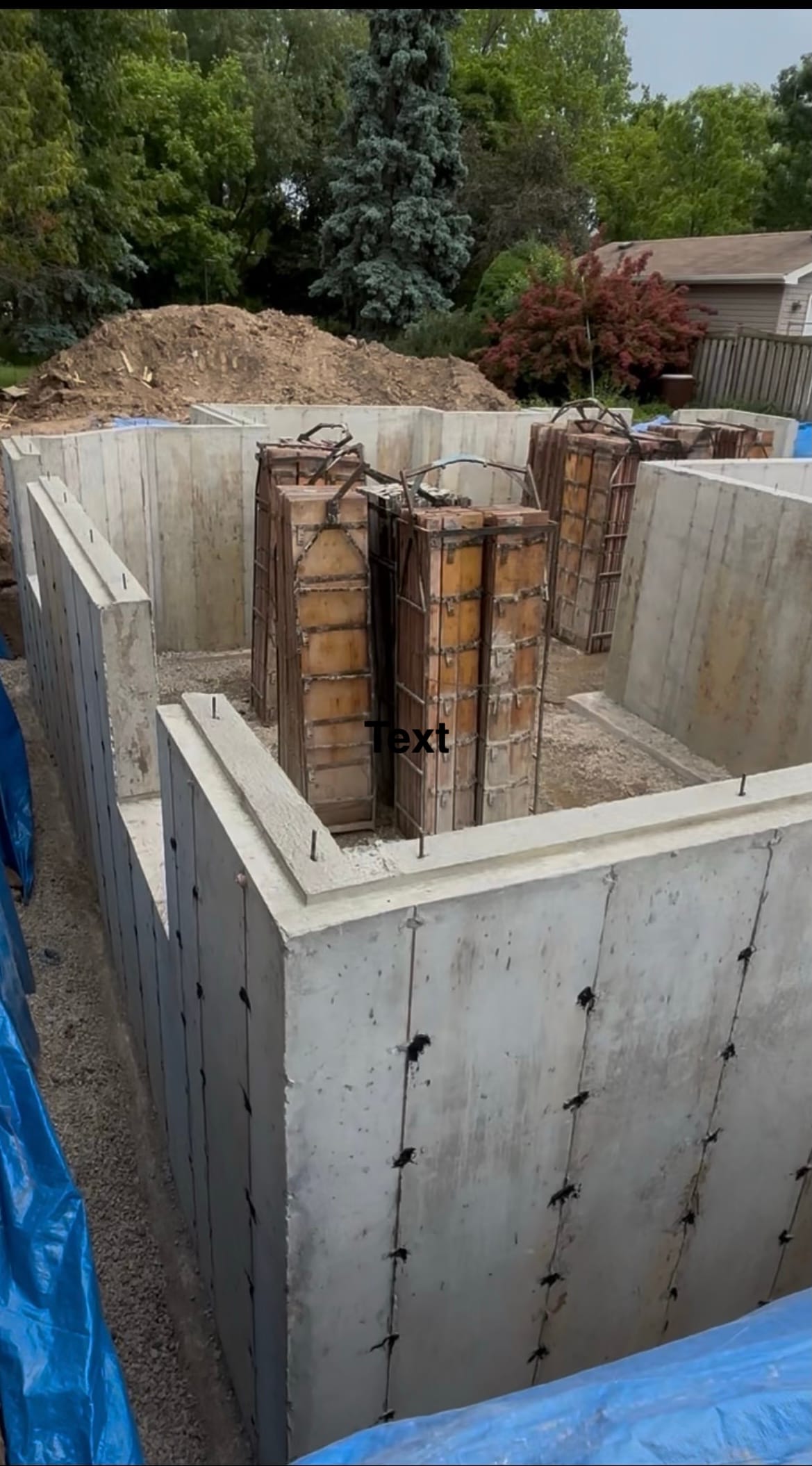 Freshly stripped foundation walls in Milton showing exposed concrete surfaces with rebar cages ready for loading
