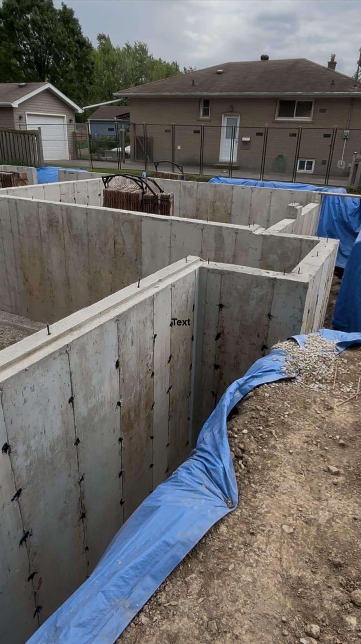 Braced foundation wall formwork system at Milton residential construction site before concrete pour