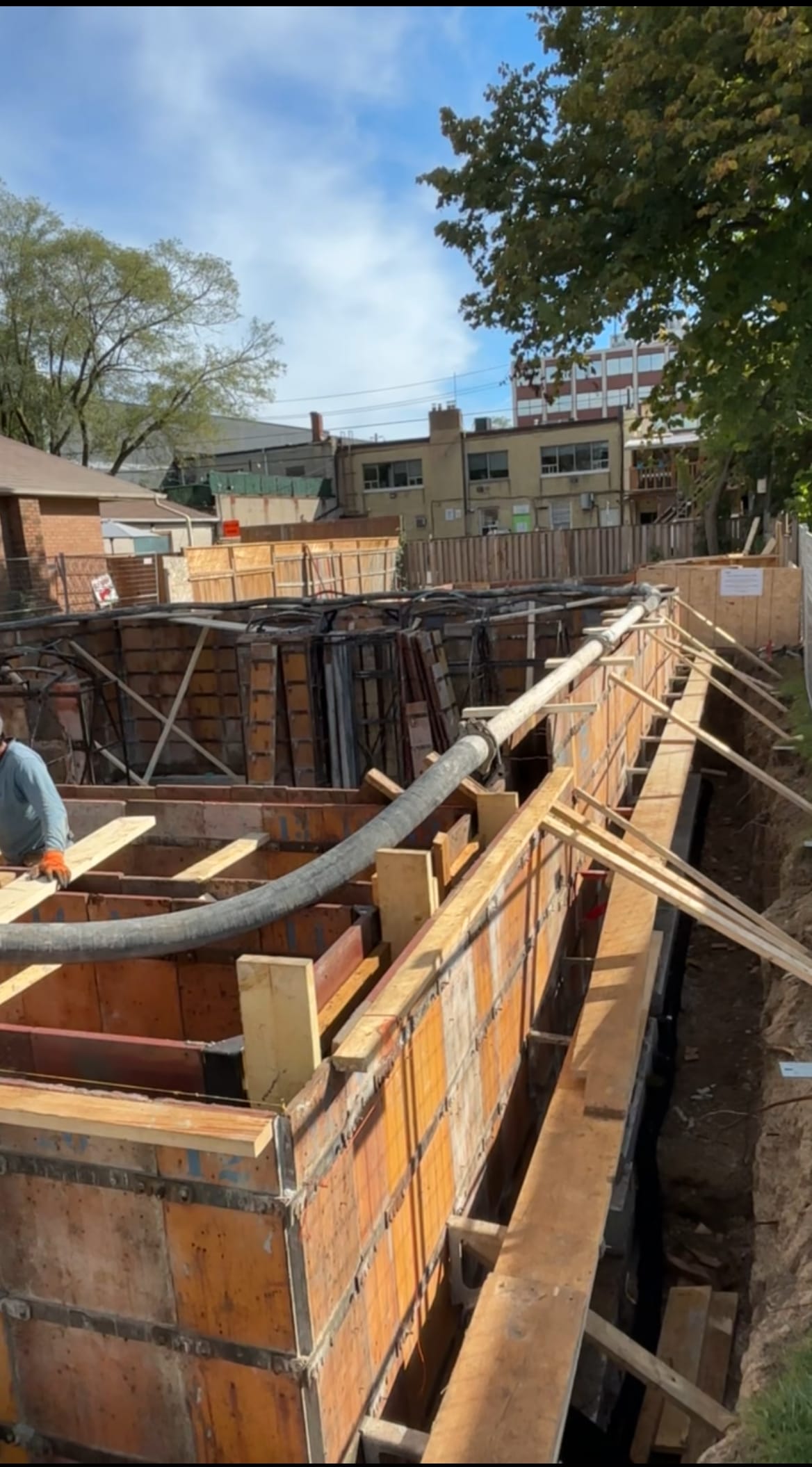 Line pump routing around multiplex foundation walls during North York concrete pour