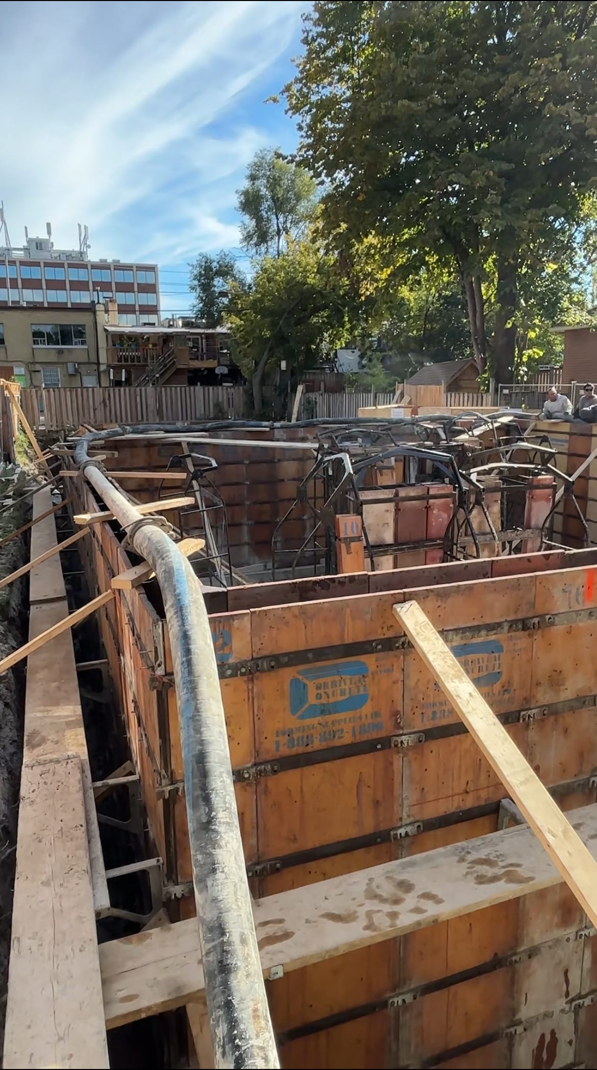 Multiplex foundation walls receiving concrete through line pump in North York