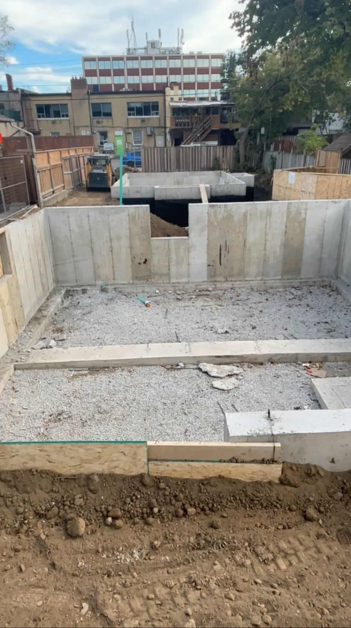 Waterproofed and backfilled multiplex walls with garden suite foundation in North York