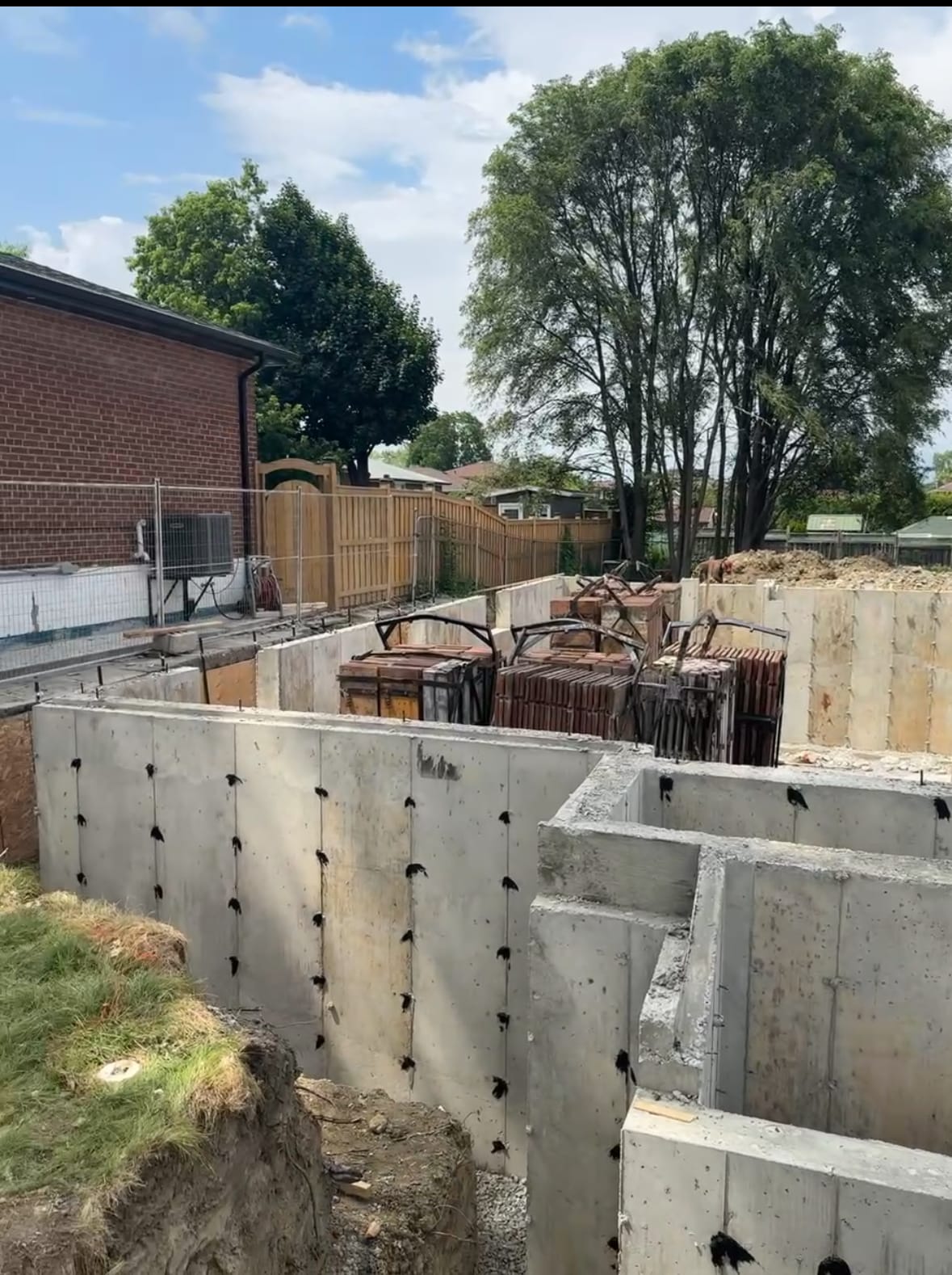 Stripped concrete foundation walls ready for waterproofing in North York residential construction project