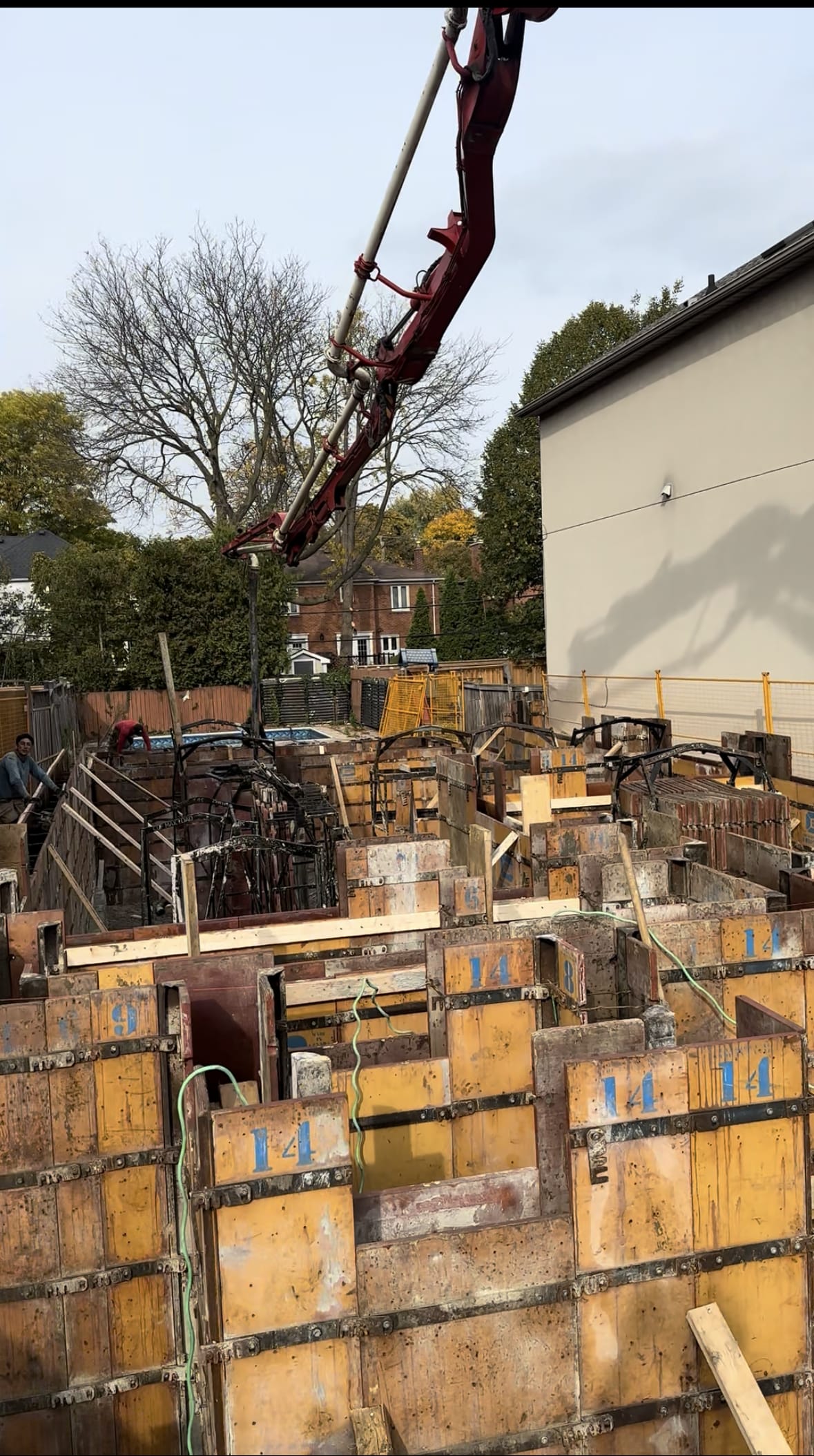 North York residential foundation with stone slinger placing drainage gravel for waterproofing