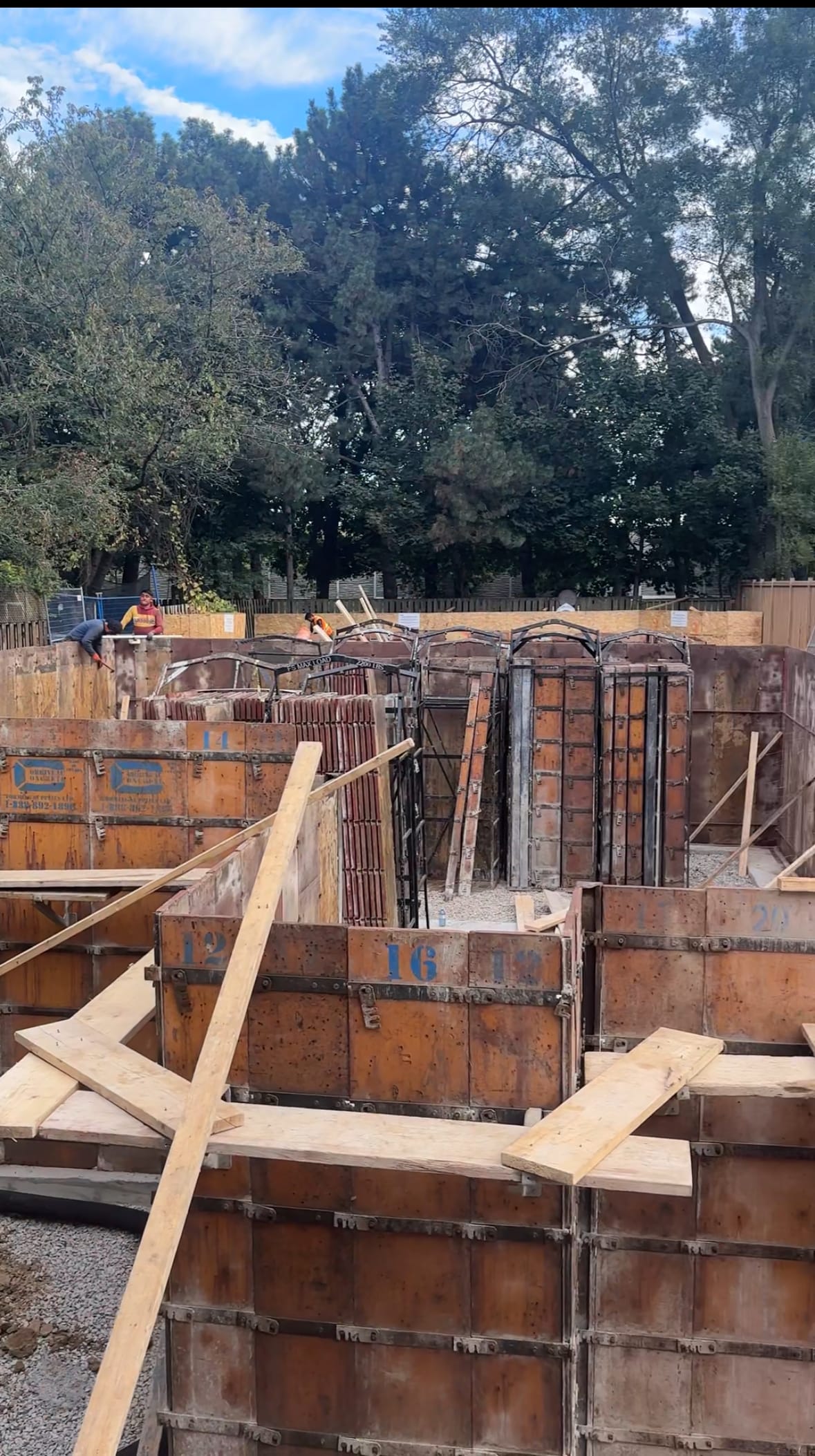 North York multiplex and garden suite foundations under construction with simultaneous wall assembly
