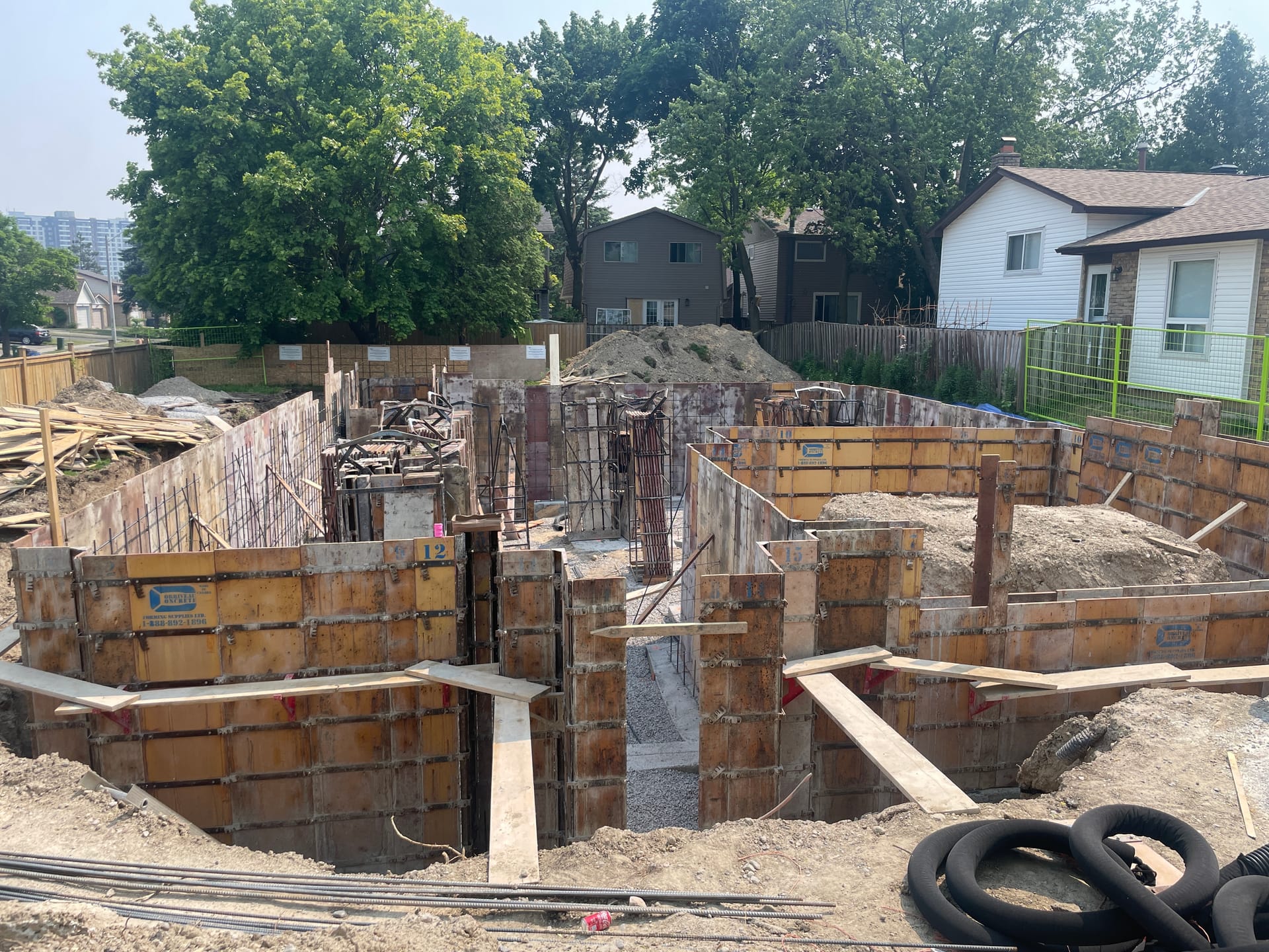 Stripped foundation walls with waterproofing application beginning in Pickering Durham Region