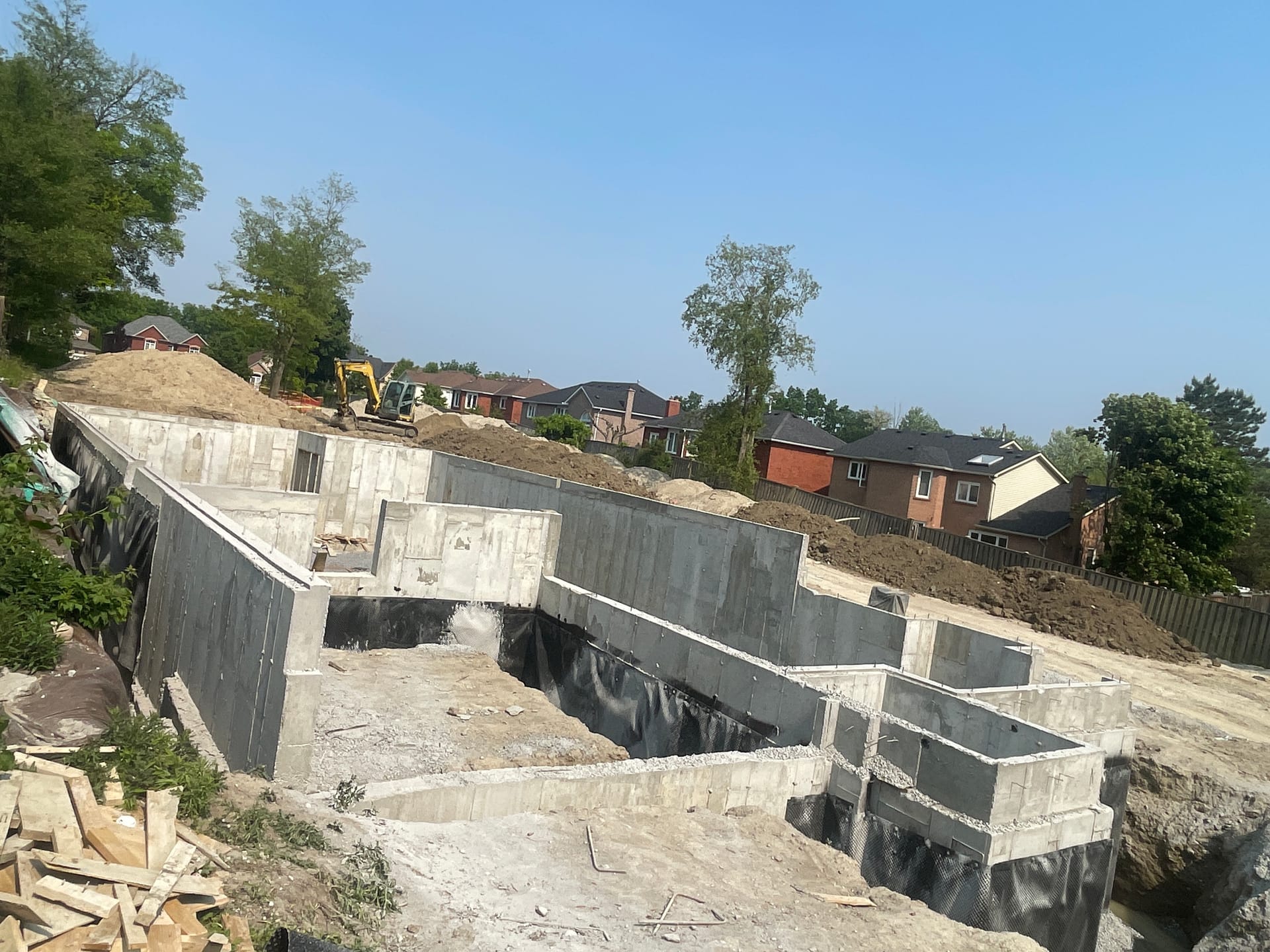 Rear elevation foundation walls during waterproofing application Pickering residential project