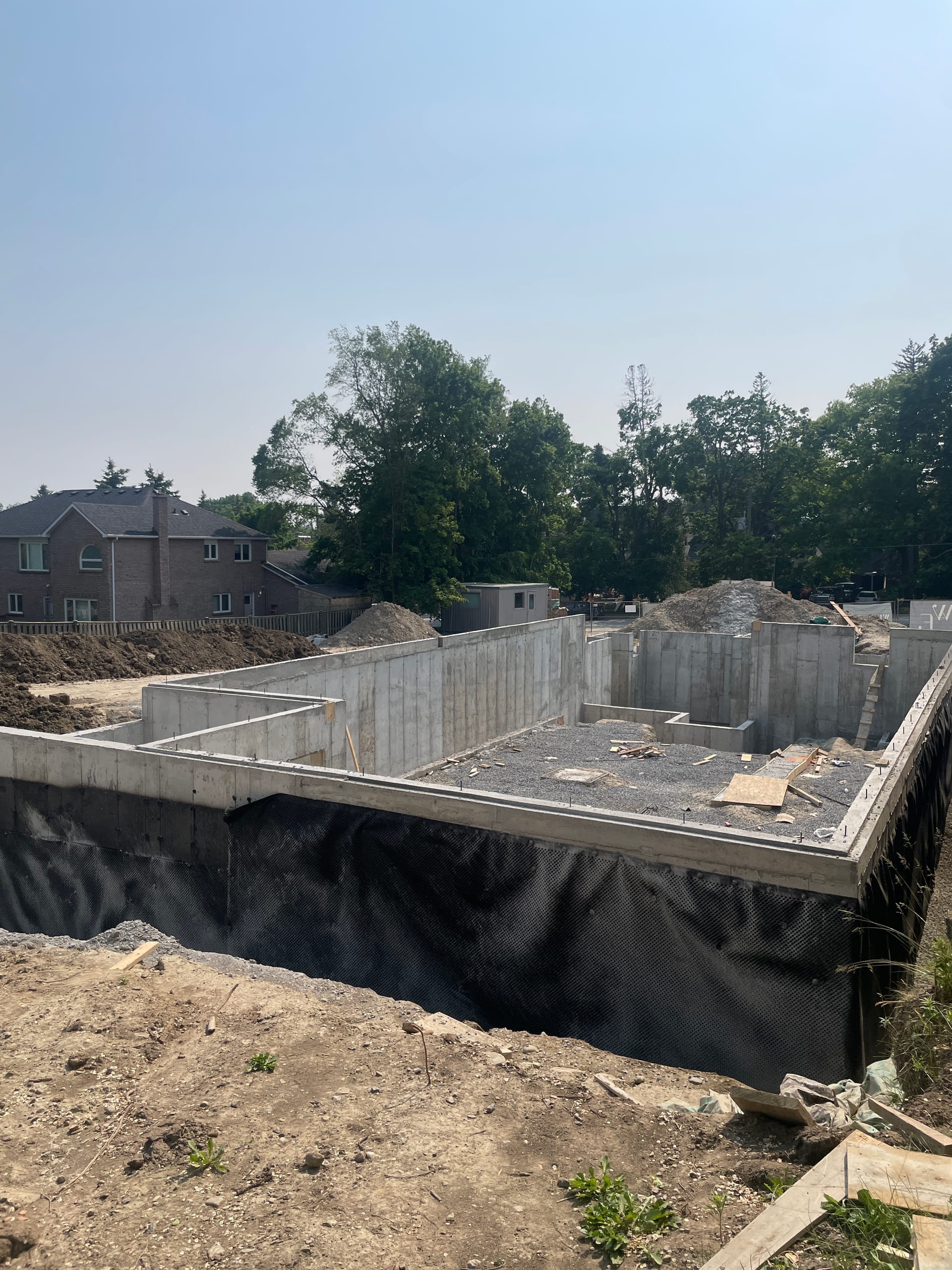 Alternate view Pickering foundation walls showing completed waterproofing membrane installation