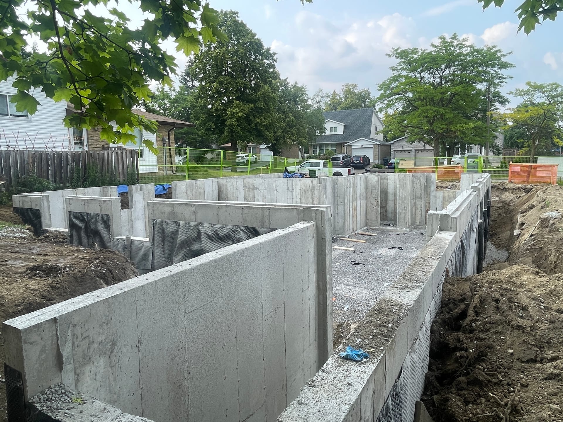 Concrete pump truck and crew pouring foundation walls at Scarborough residential project site