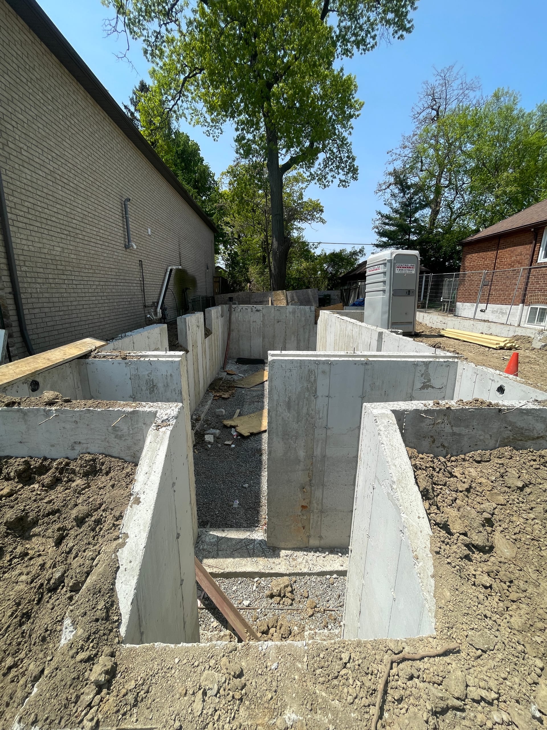 Scarborough residential foundation project with backfilled concrete walls and site preparation complete