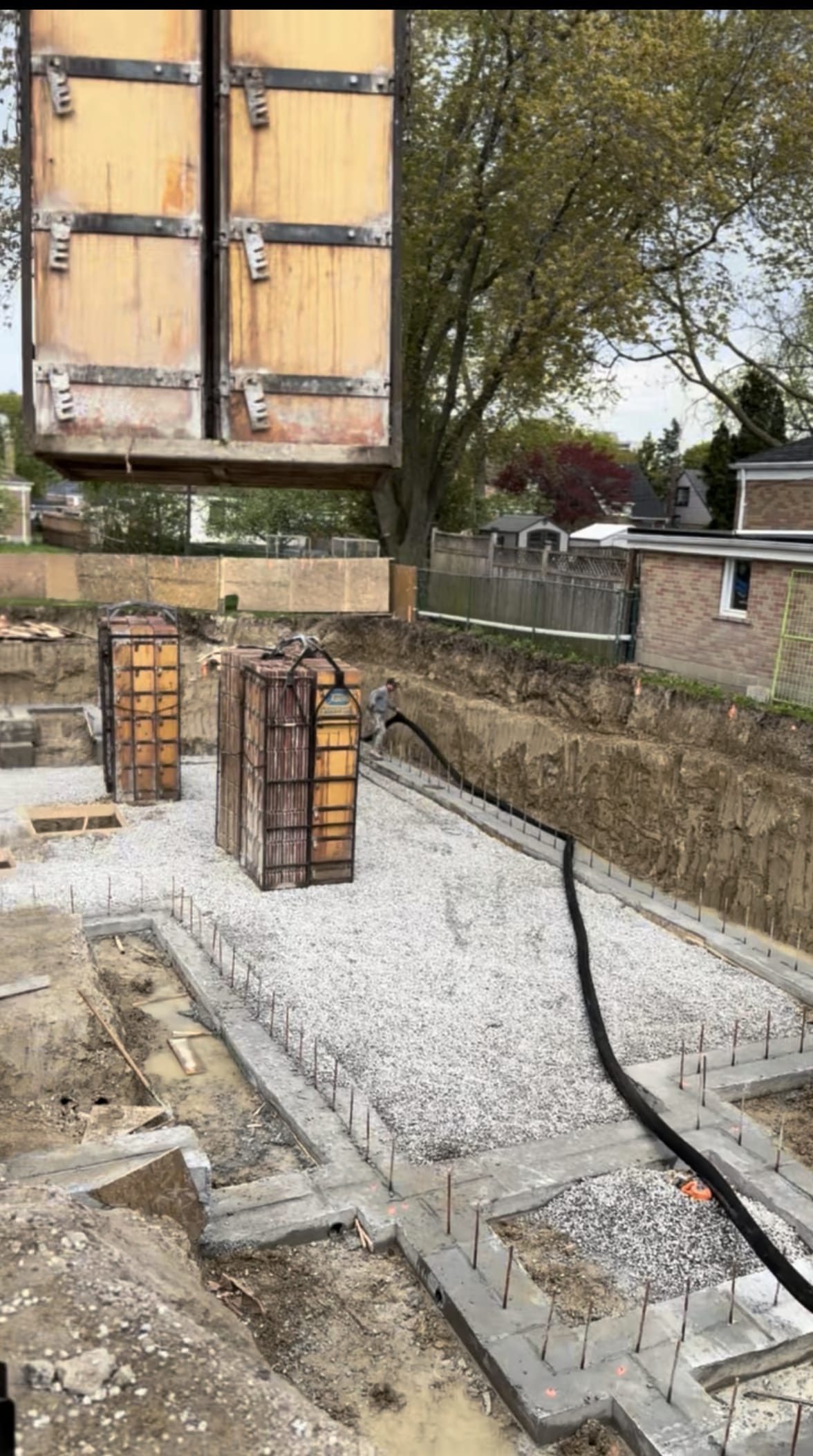 Foundation waterproofing application on completed concrete walls at Scarborough residential site