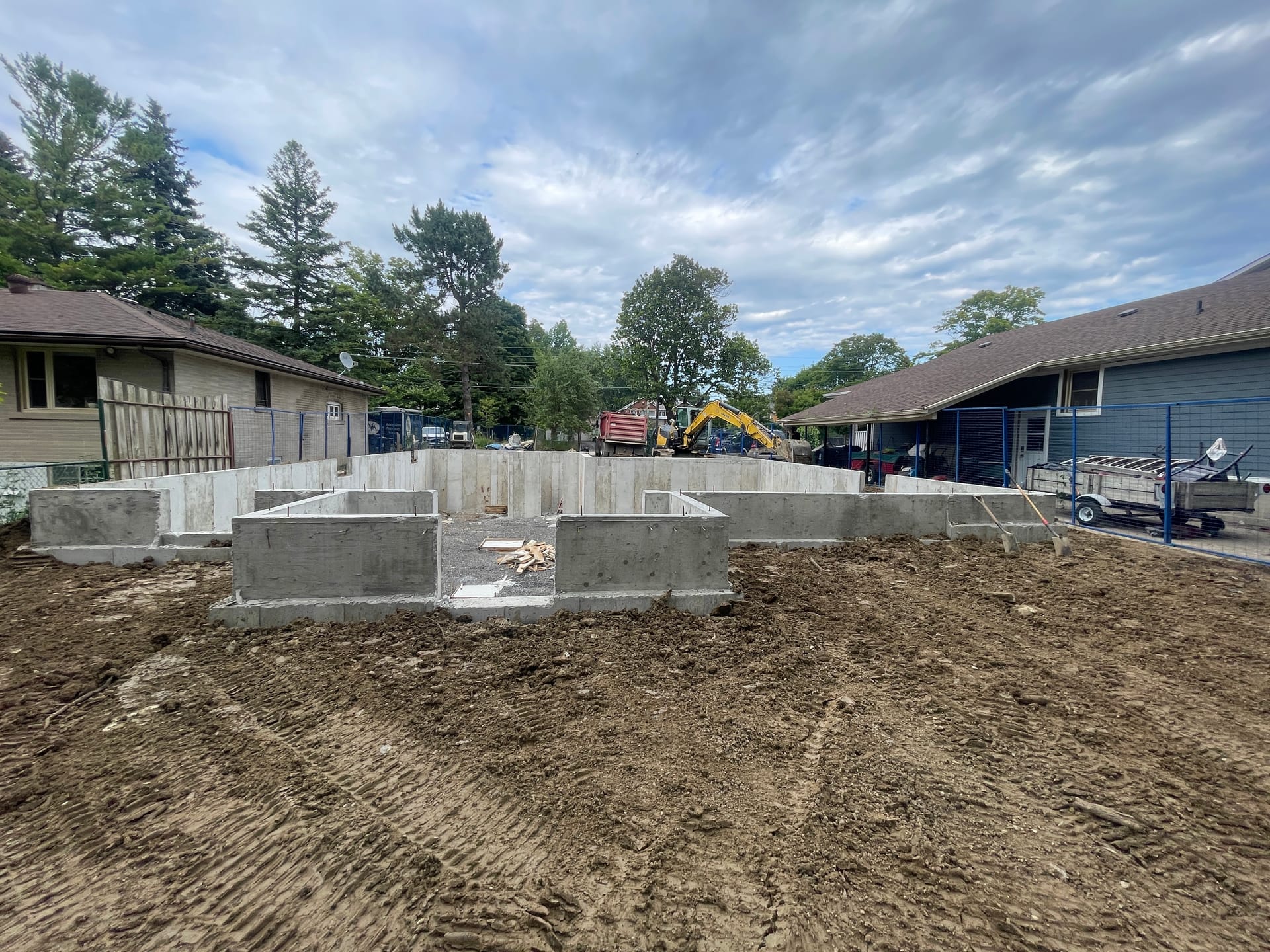 Backfilled foundation walls for Scarborough custom home showing proper grading and drainage