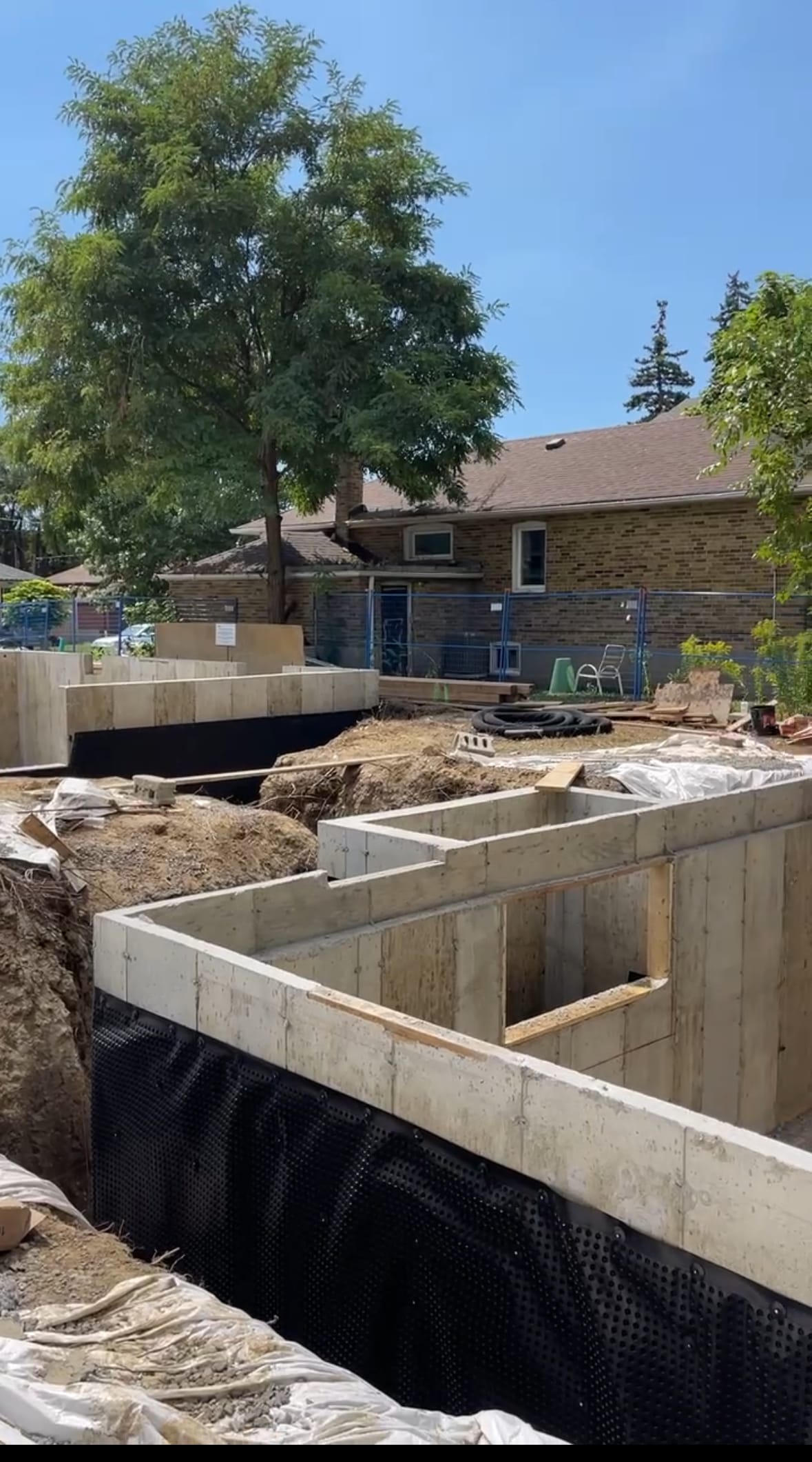 Waterproofed garden suite foundation walls in Scarborough displaying completed membrane application