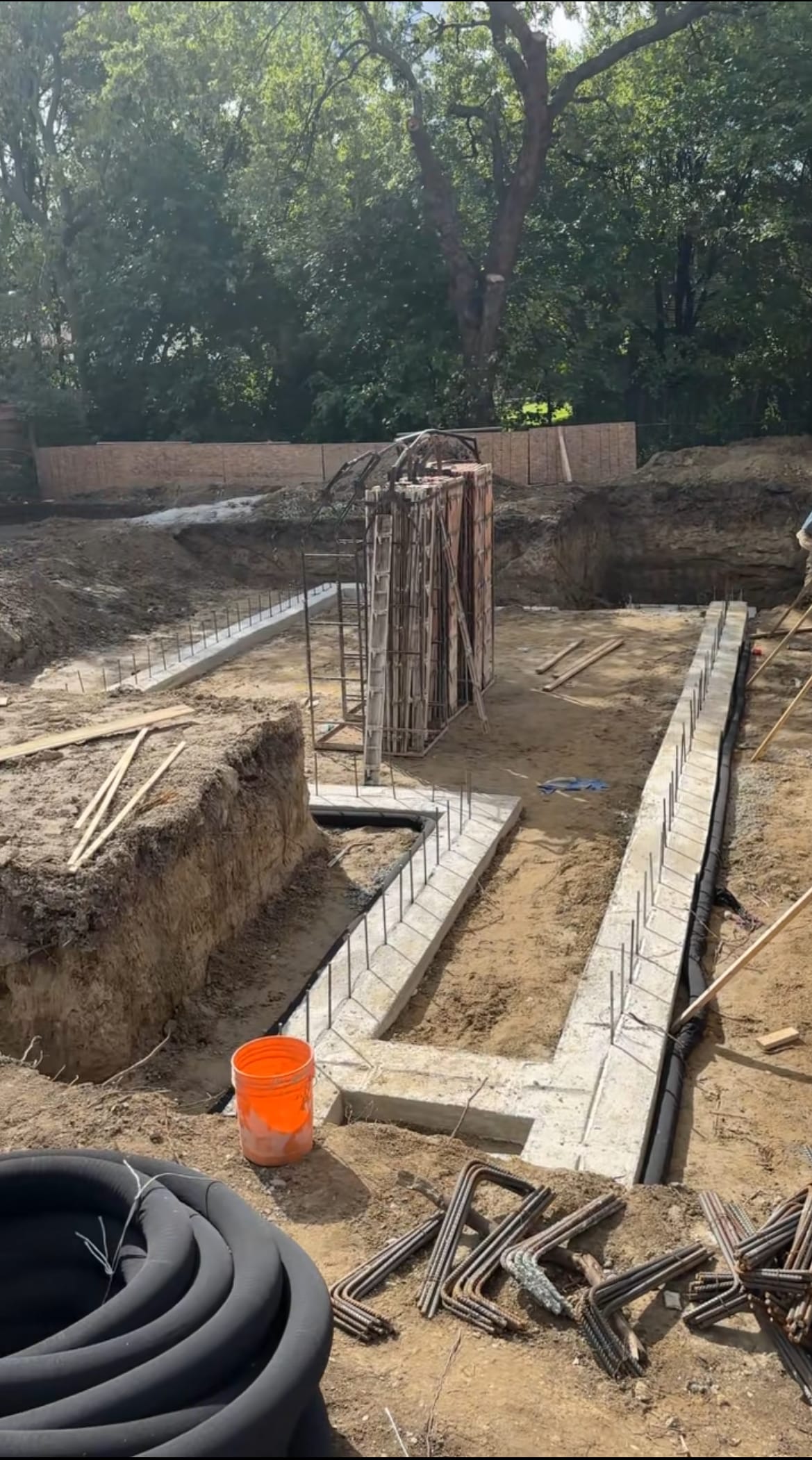 Rebar cage installation following footing pour at Scarborough residential foundation site