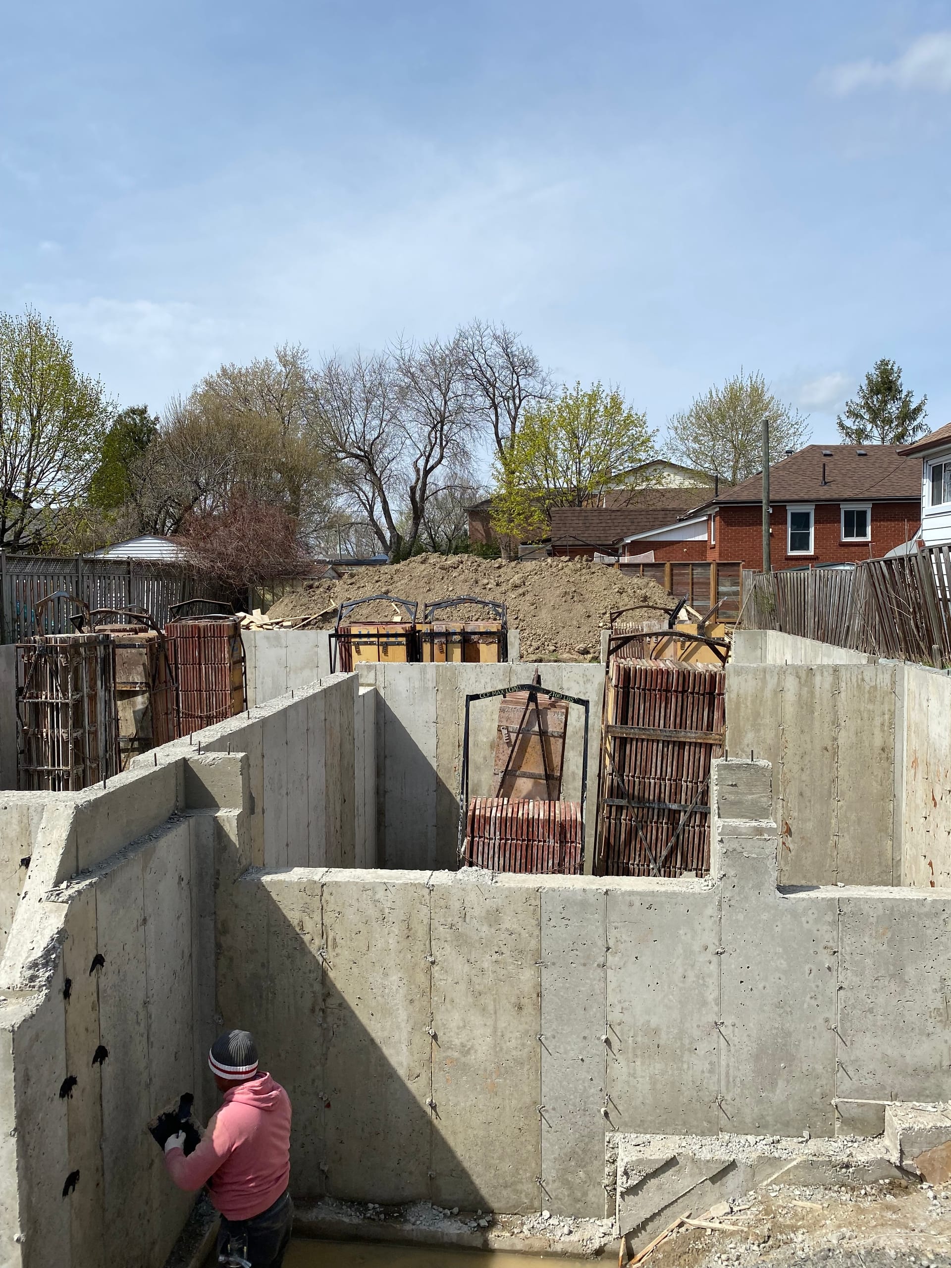 Completed Scarborough foundation walls receiving waterproofing treatment with cement hole patching