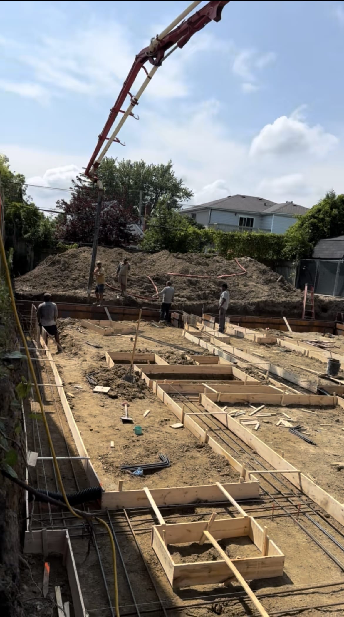 Foundation footing concrete placement in progress at Scarborough residential site
