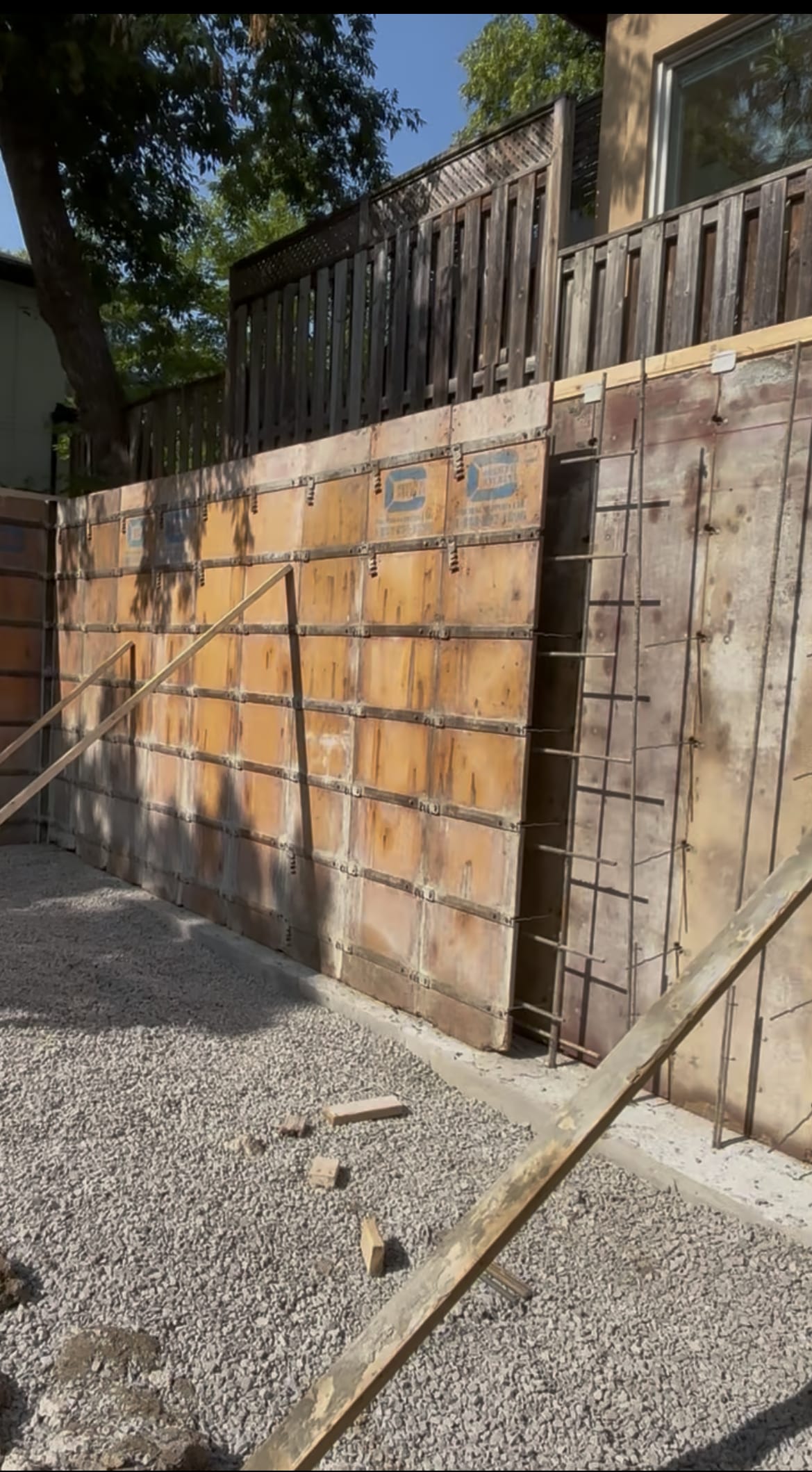 Extension foundation forms placed against existing foundation