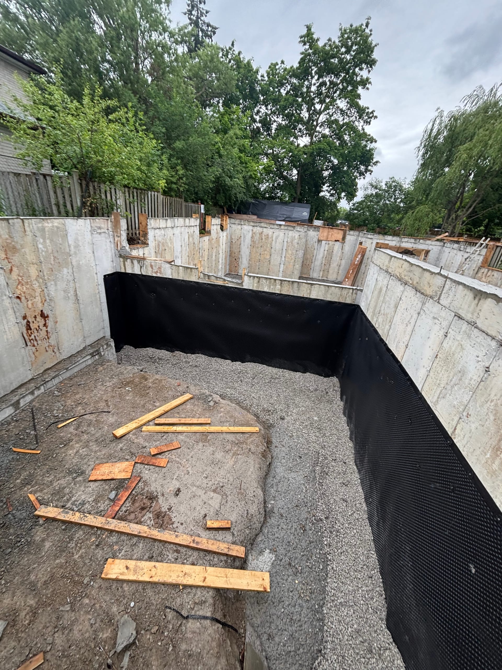 Toronto foundation extension with installed rebar and braced formwork during wall assembly phase