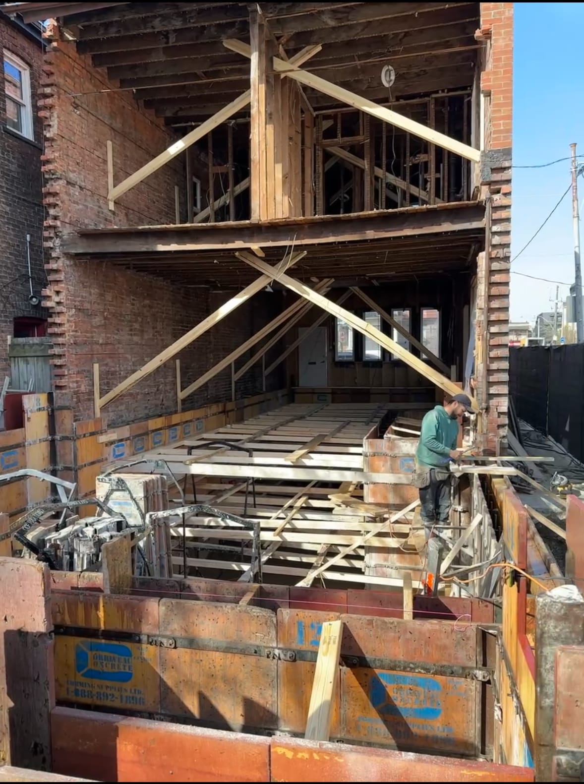 Foundation waterproofing application in progress on residential extension project Toronto