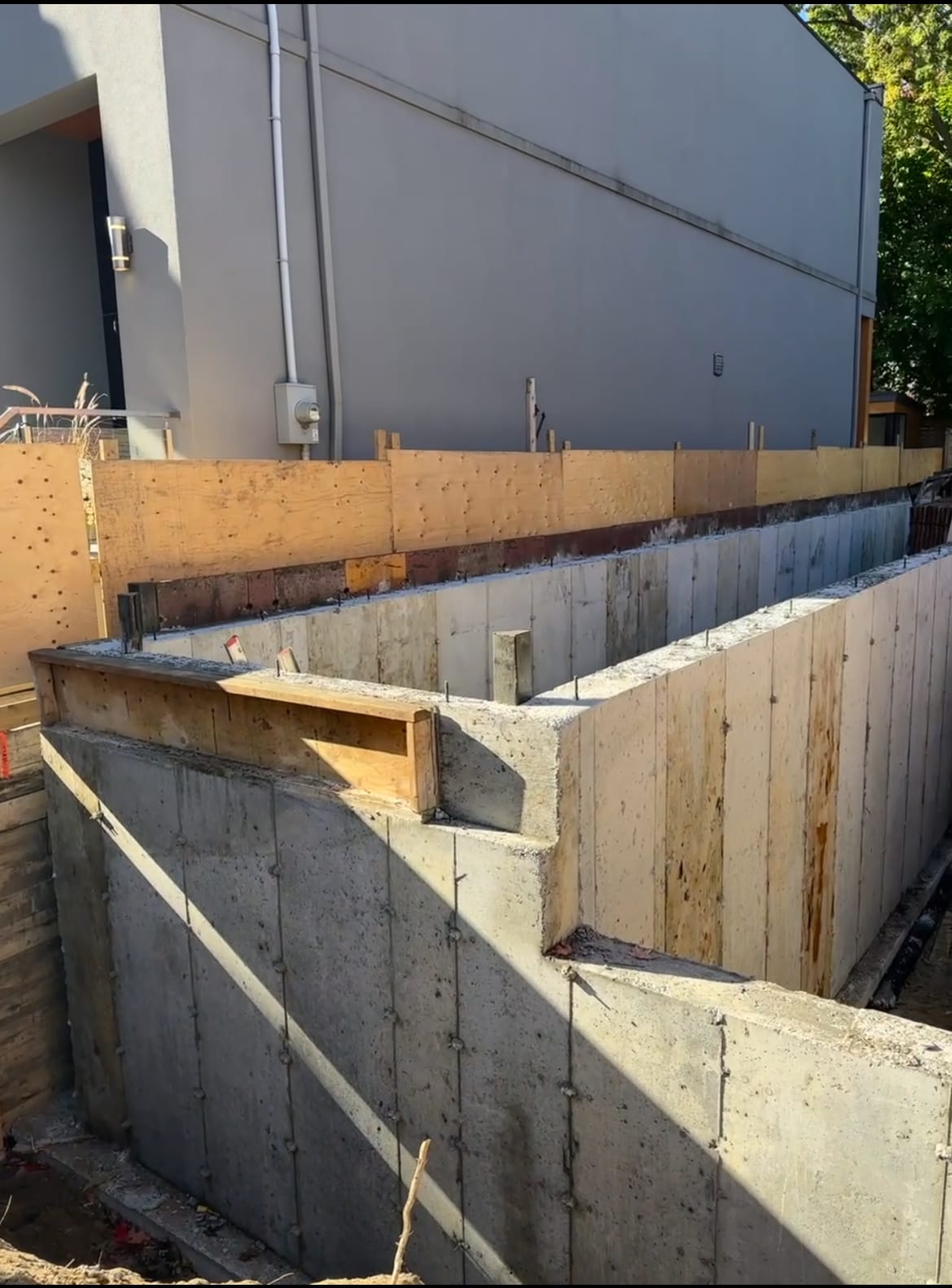 Completed foundation walls with waterproofing underway for Toronto residential project