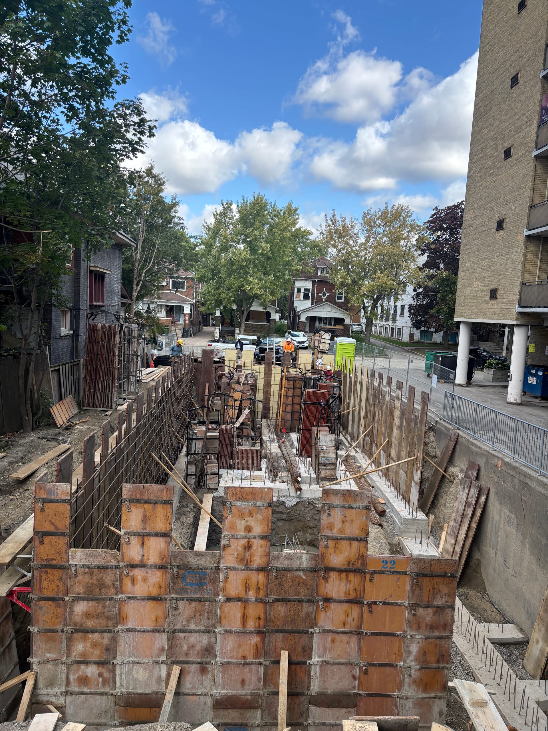 Toronto multiplex foundation showing rebar placement and completed footing work during wall assembly