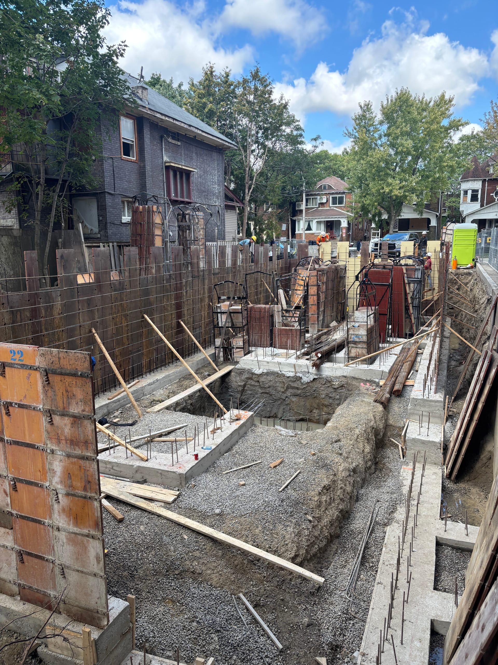 Concrete pump truck pouring foundation for multiplex construction project in Toronto