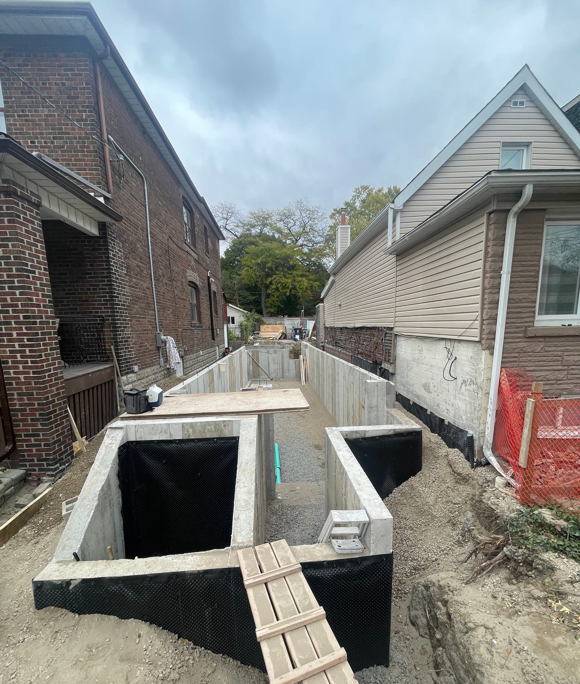 Completed foundation walls with backfill underway for residential foundation project in Toronto